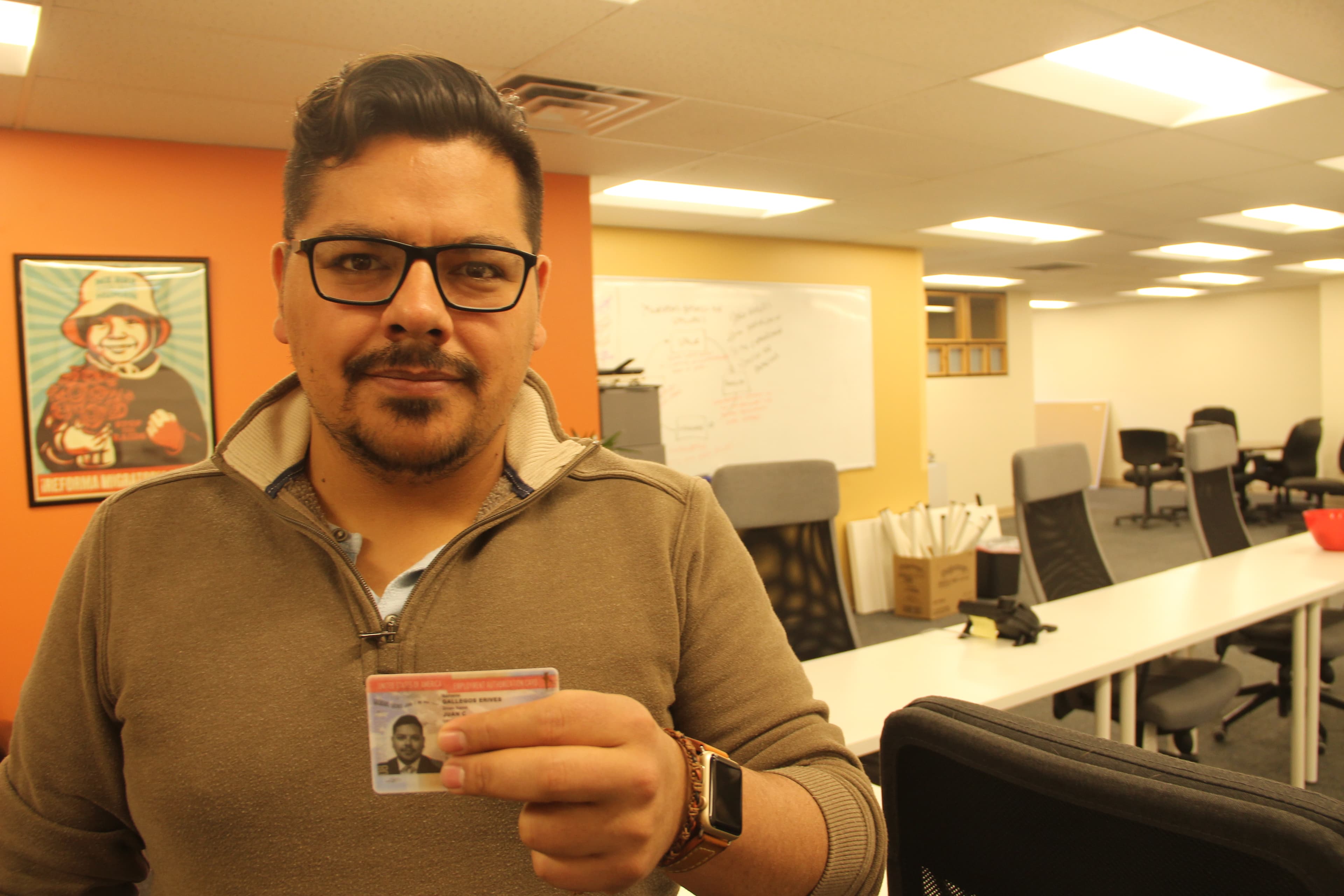 Juan Gallegos holds his US employment authorization card issued to DACA recipients. His legal status, and ability to work legally in the US, ends August 28, 2019.