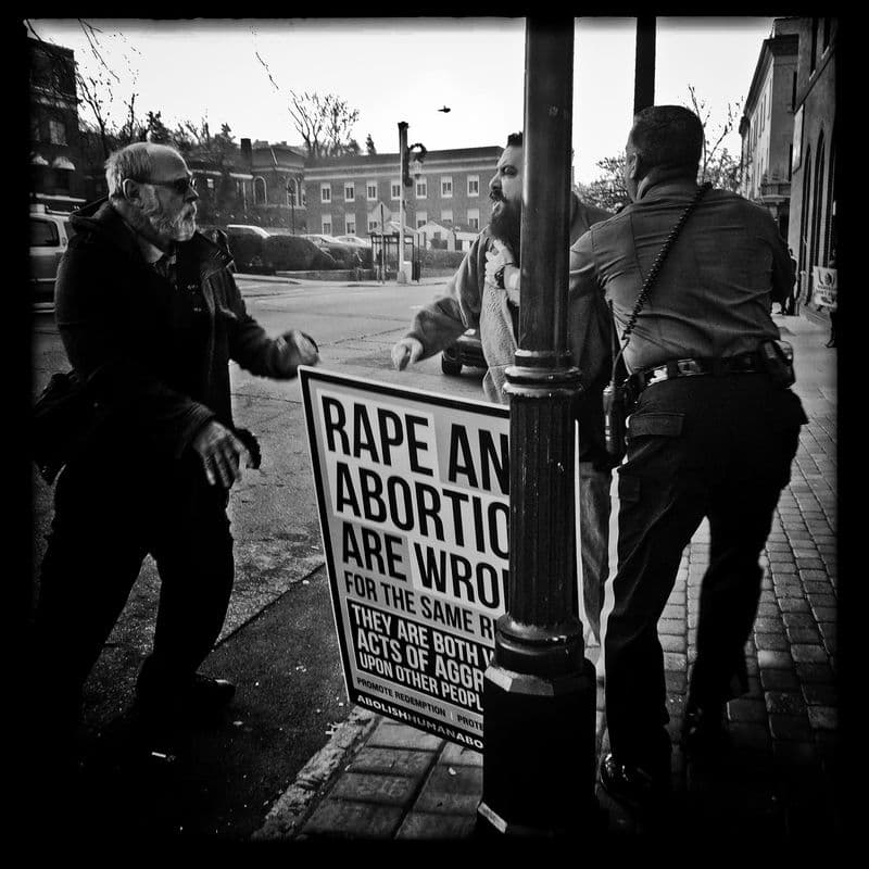 A protester confronts a man who accompanied his partner to Metropolitan Medical Associates clinic in New Jersey.