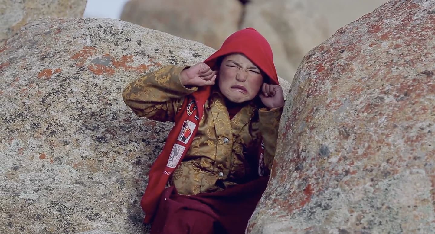 Padma Angdu plugs his ears to block out the frightening noise of firecrackers.