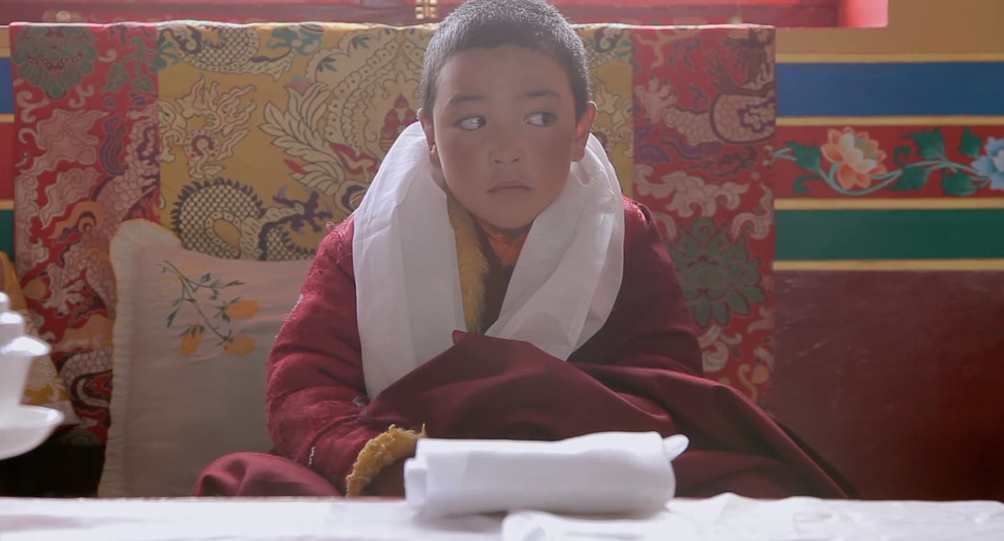 Padma Angdu sits on a throne and awaits veneration from elder followers.