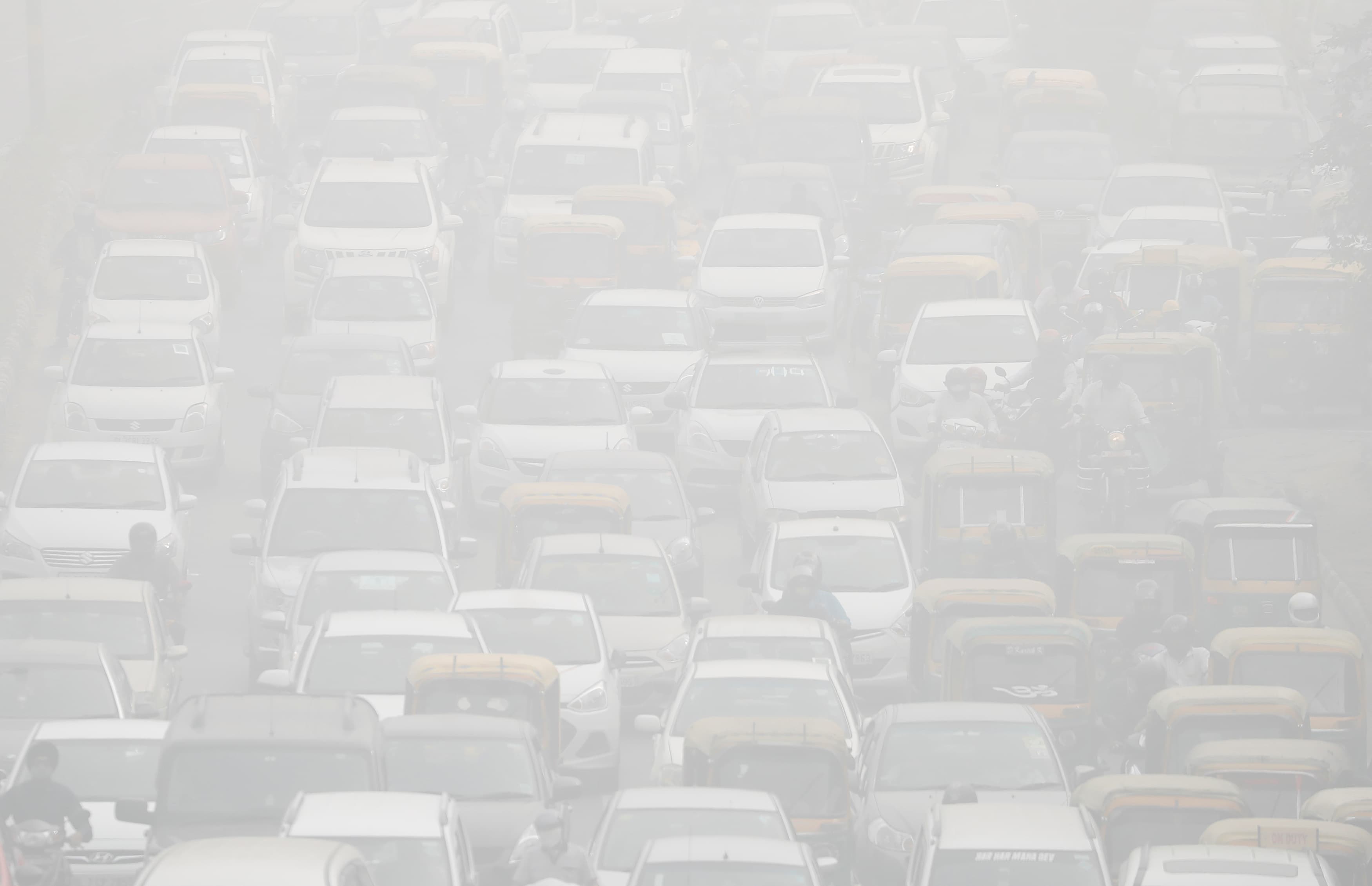 Vehicles drive through heavy smog in Delhi during the peak of the most recent pollution crisis, Nov. 8, 2017.