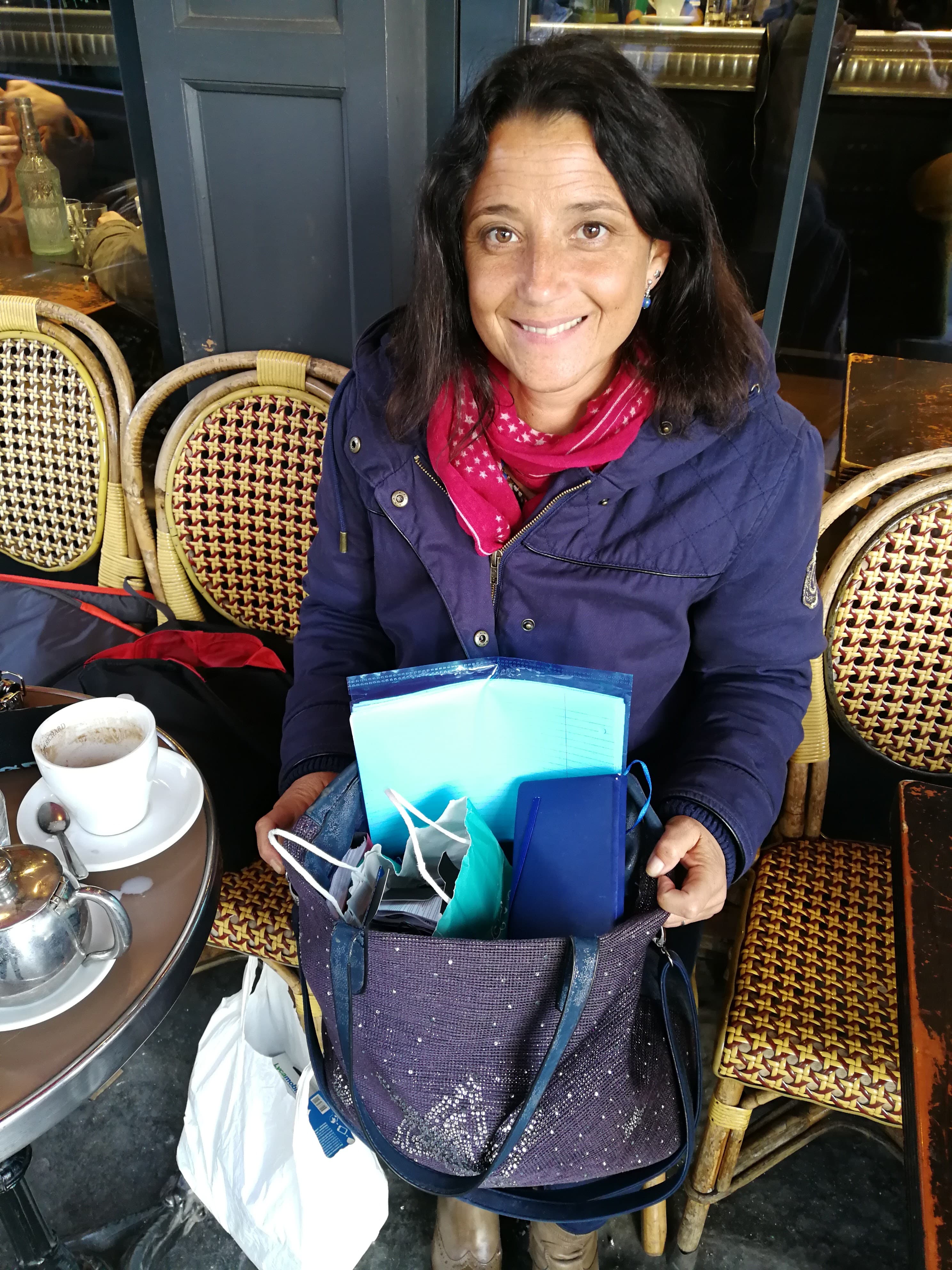 A woman sits holding a bag full of cell phones and sim cards to hand out to homeless young immigrants.