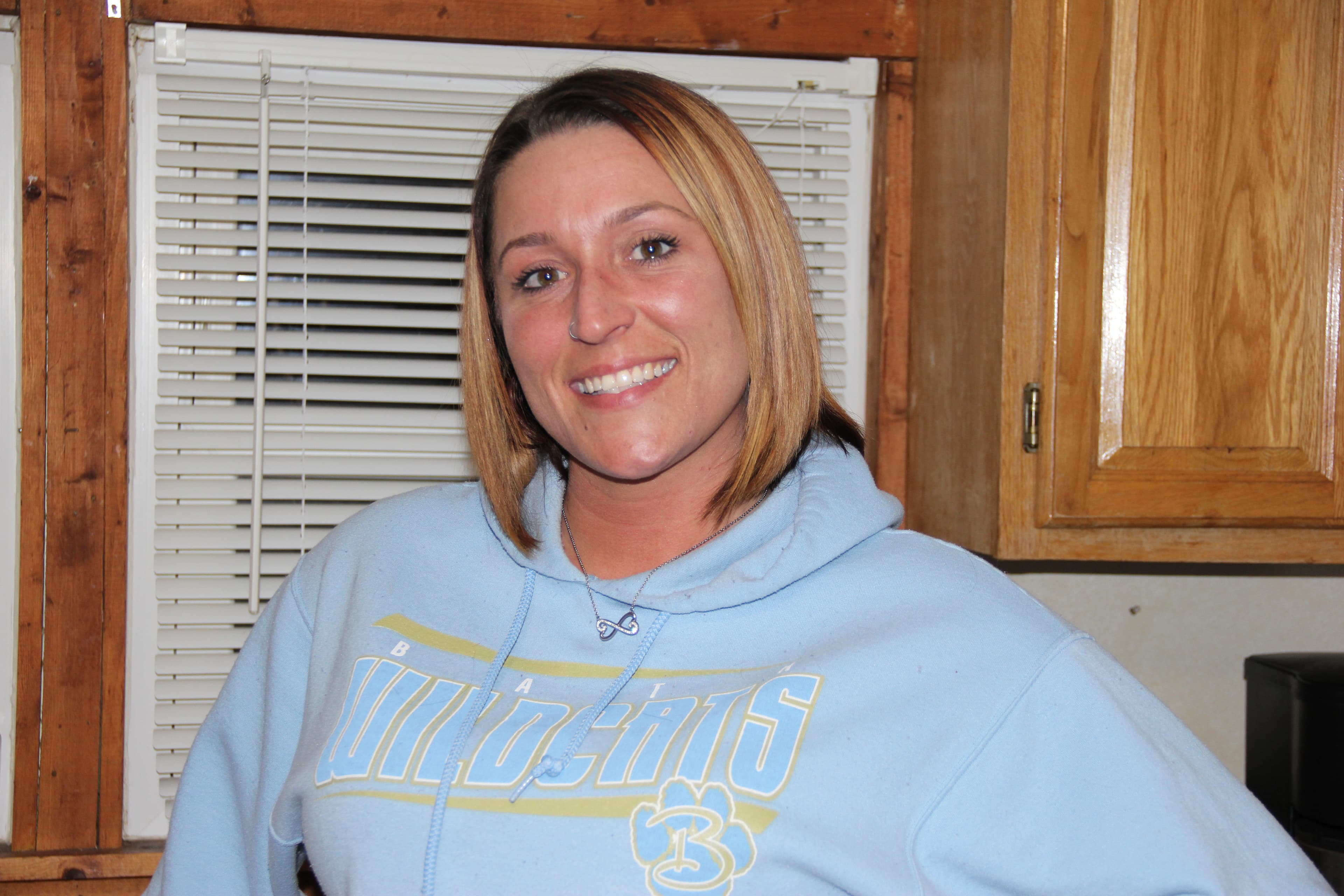 A woman in the kitchen of her house