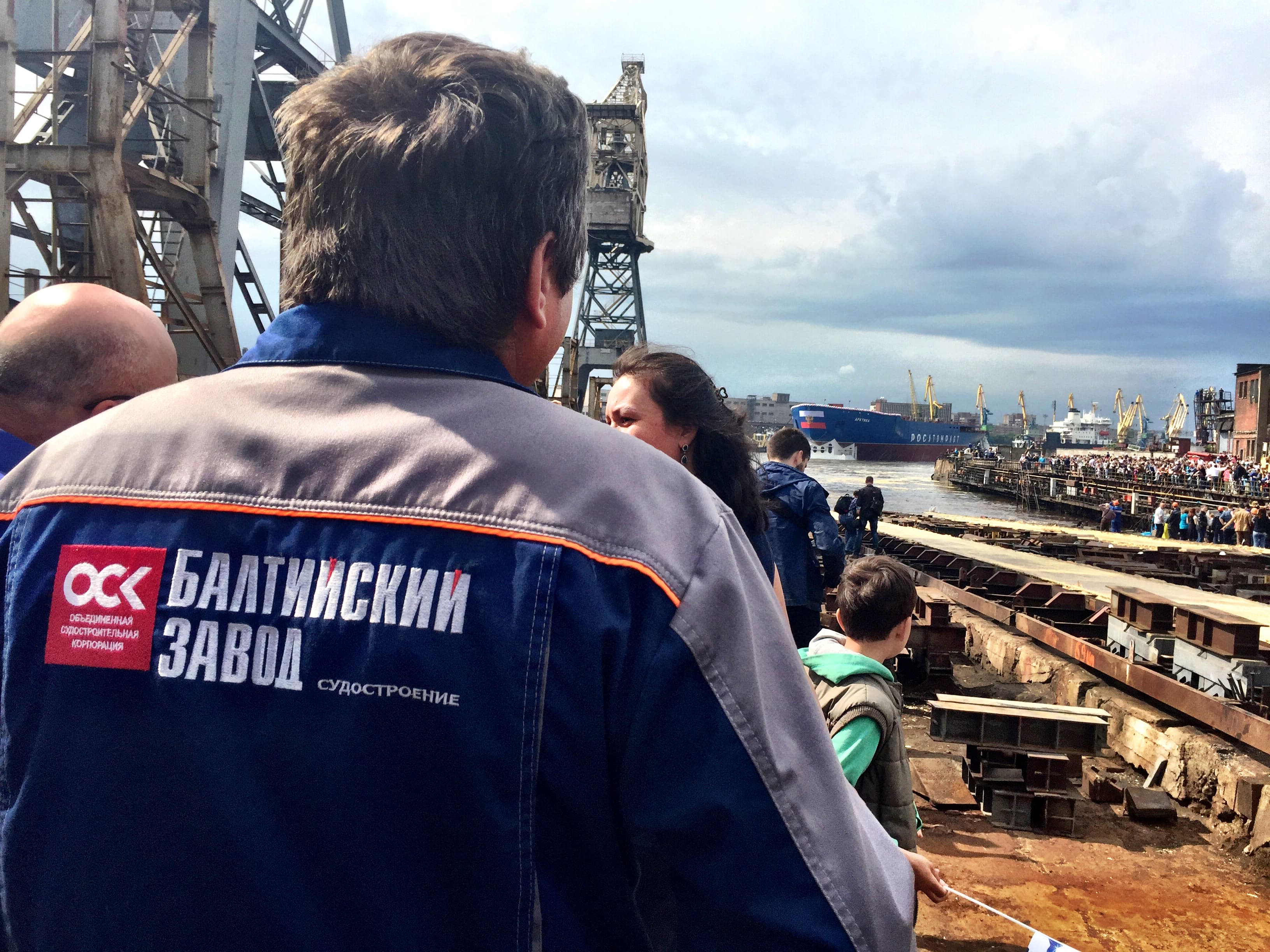 A Baltic Factory worker looks on as the Arktika hull drifts into the harbor.