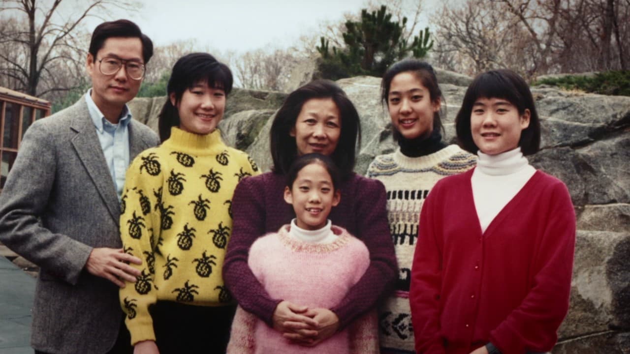 A family of six smiling for the camera.
