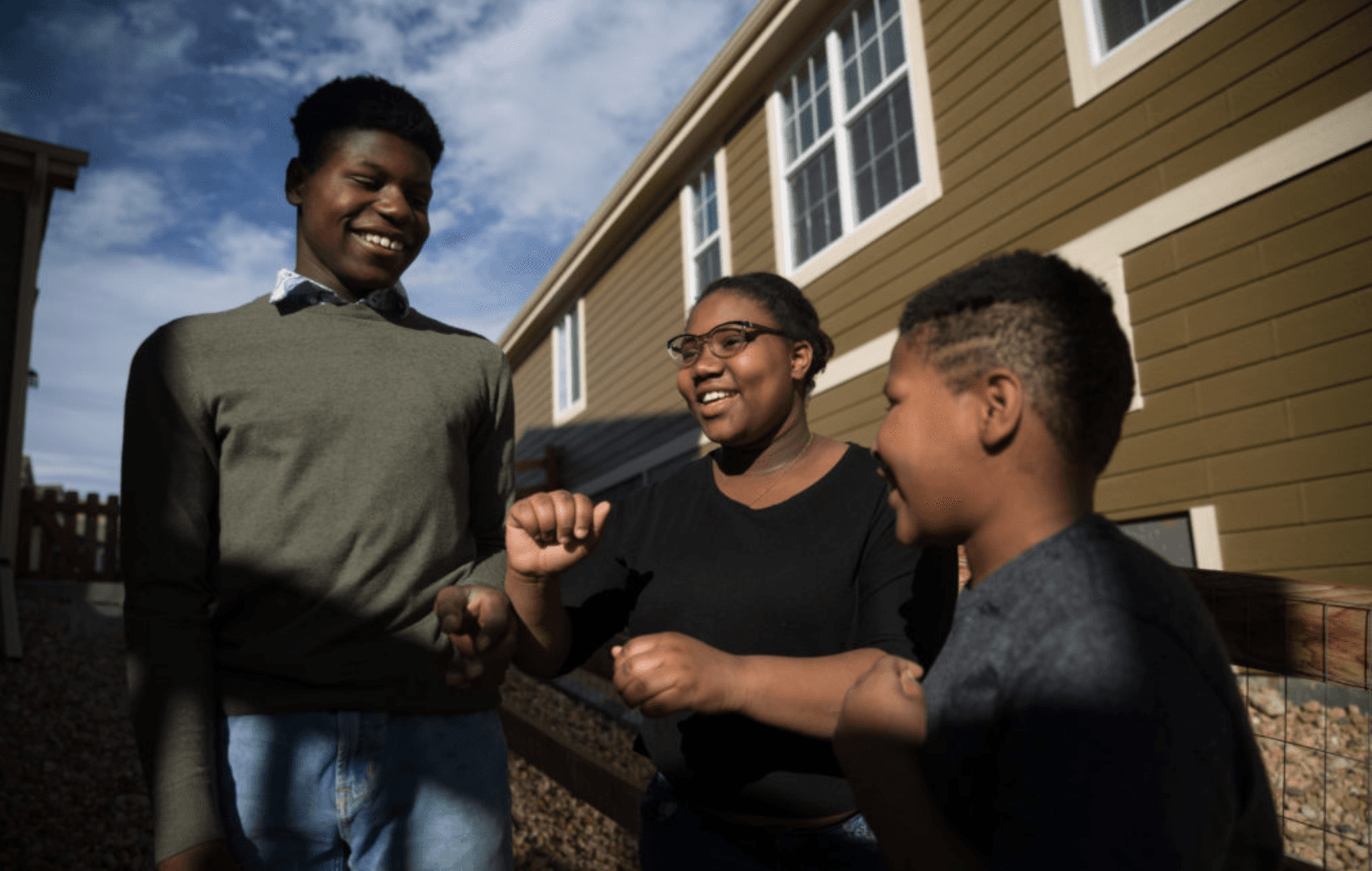Three kids at a house