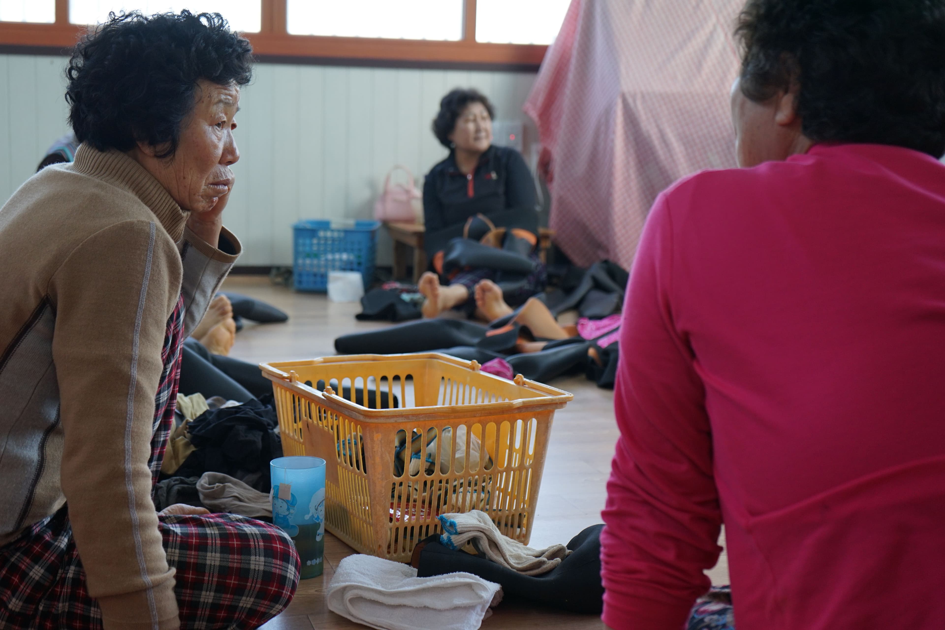 Divers at the bathhouse, where they weigh their catch and talk about their husbands, their health, and their grandkids.
