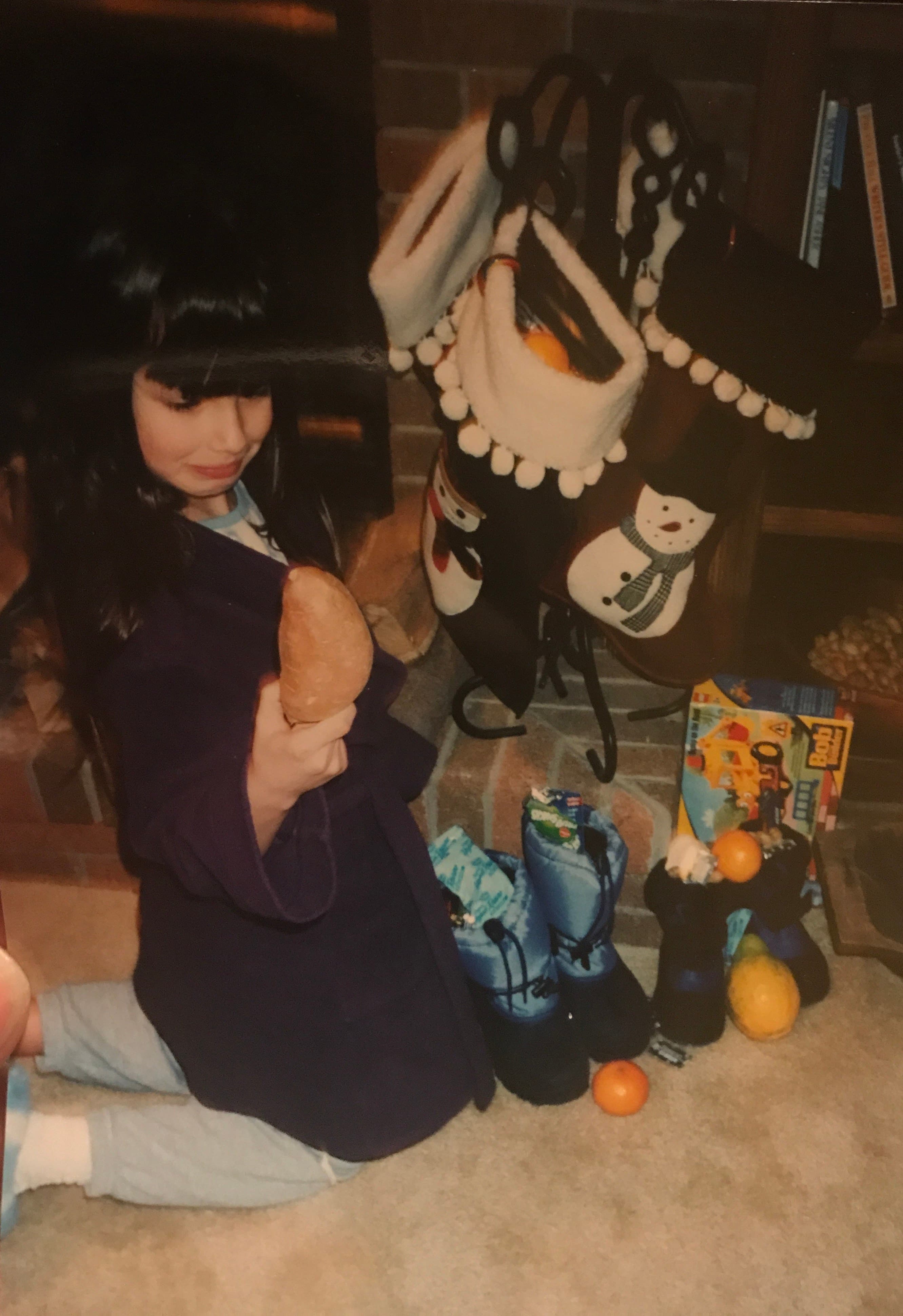 a young girl looking at a potato in shock