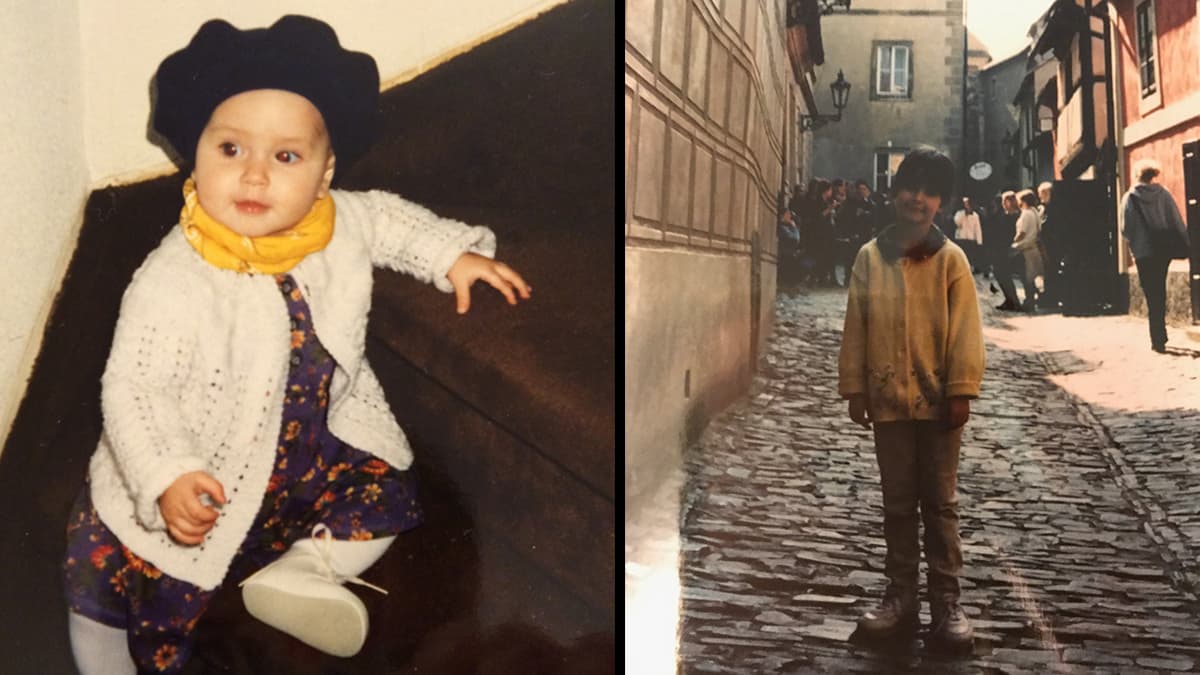 a baby sitting on steps and a child on a cobblestone street