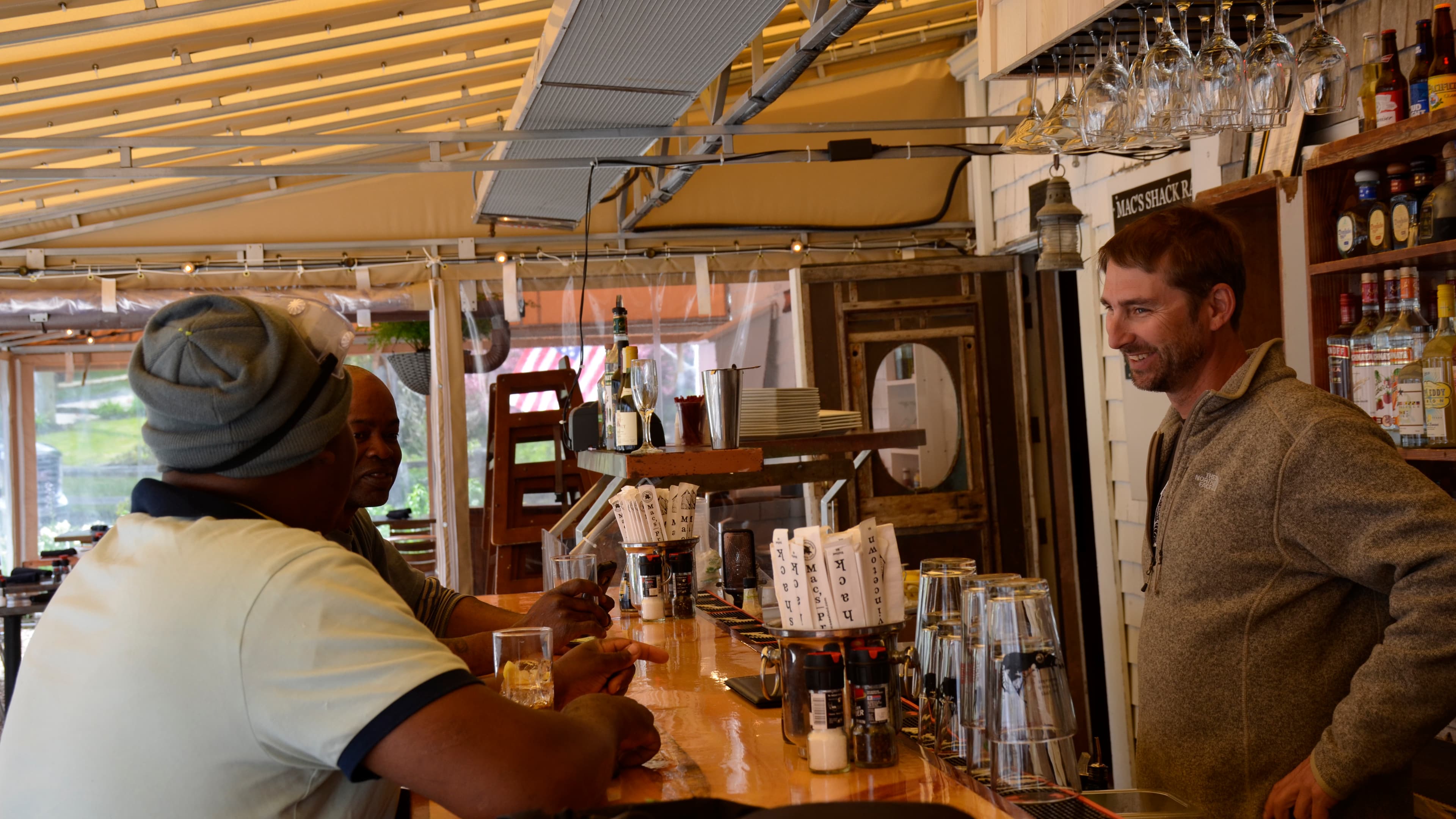 MacGregor “Mac” Hay speaks with some customers at Mac’s Shack in Wellfleet. Hay is entering his 23rd summer on the Cape running his popular Mac’s restaurants and markets.