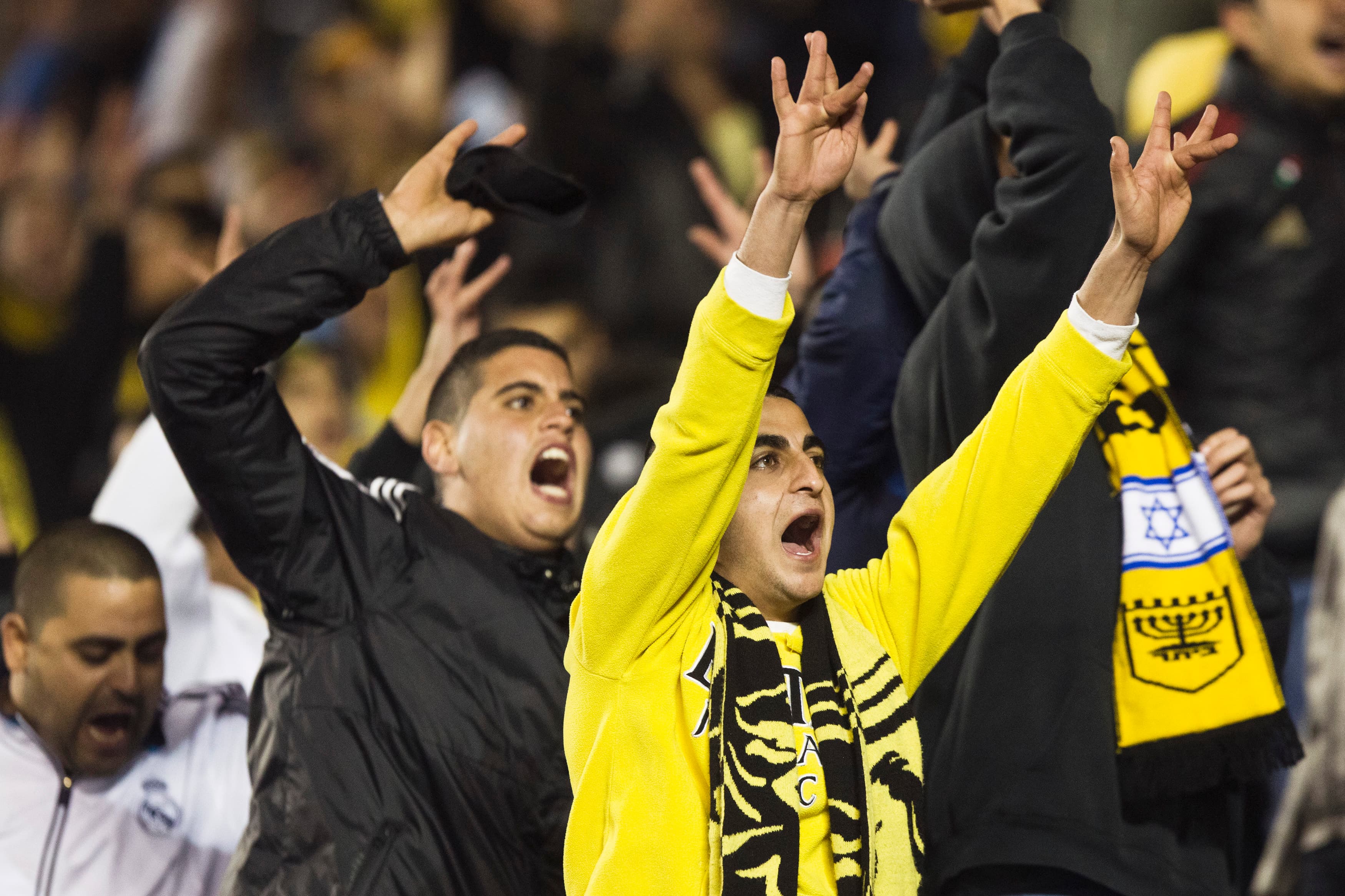 young men cheer with yellow banners