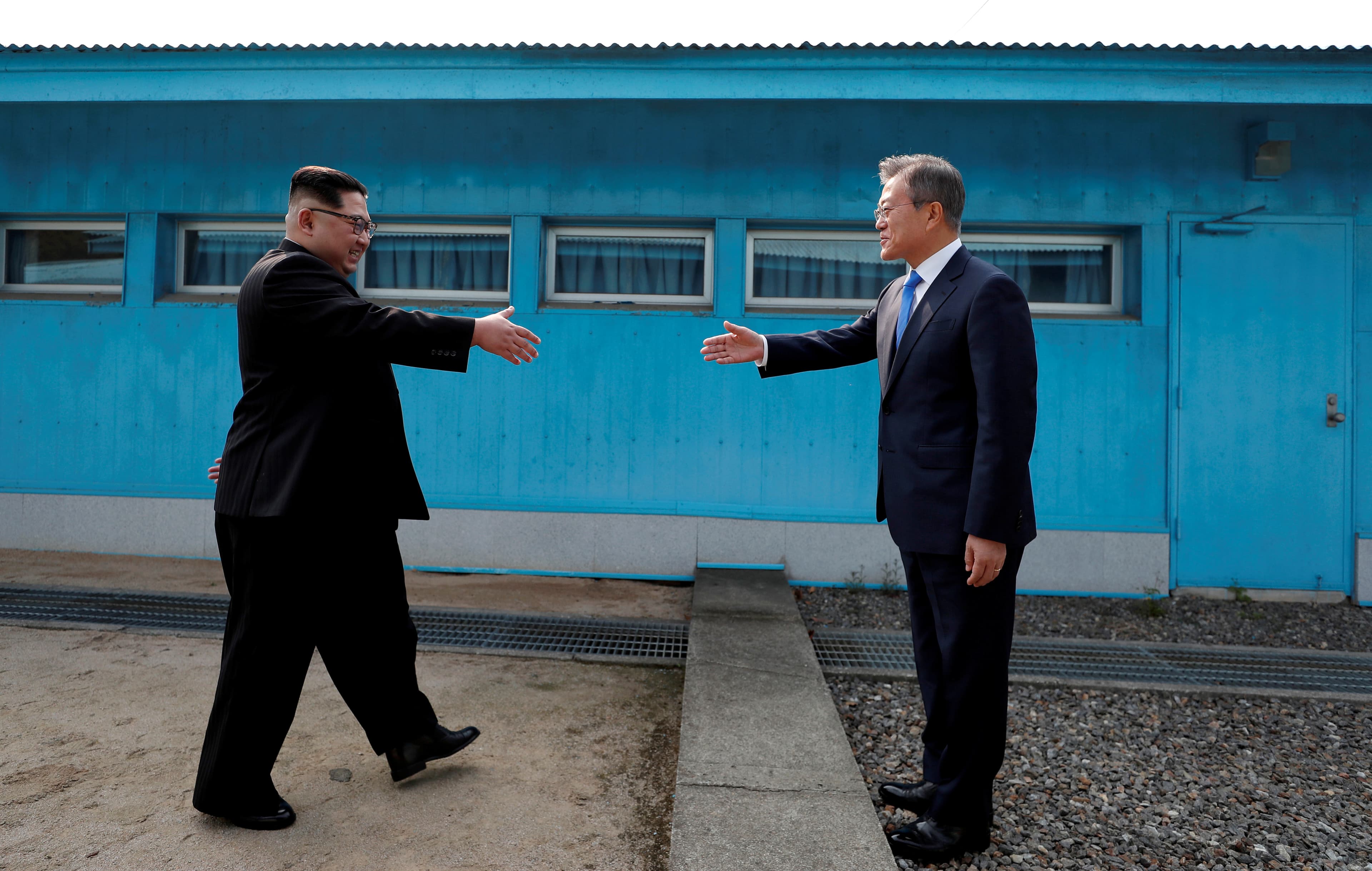 South Korean President Moon Jae-in and North Korean leader Kim Jong-un shake hands at the truce village of Panmunjom inside the demilitarized zone separating the two Koreas, South Korea, April 27, 2018.
