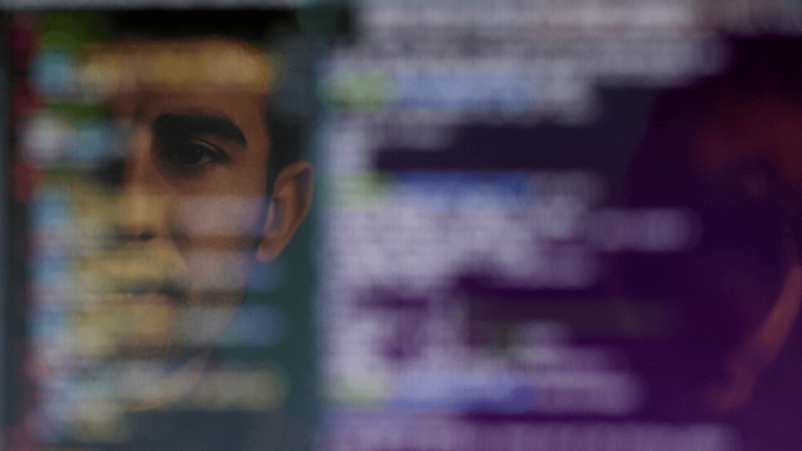 a man looks at an algorithm on a computer screen