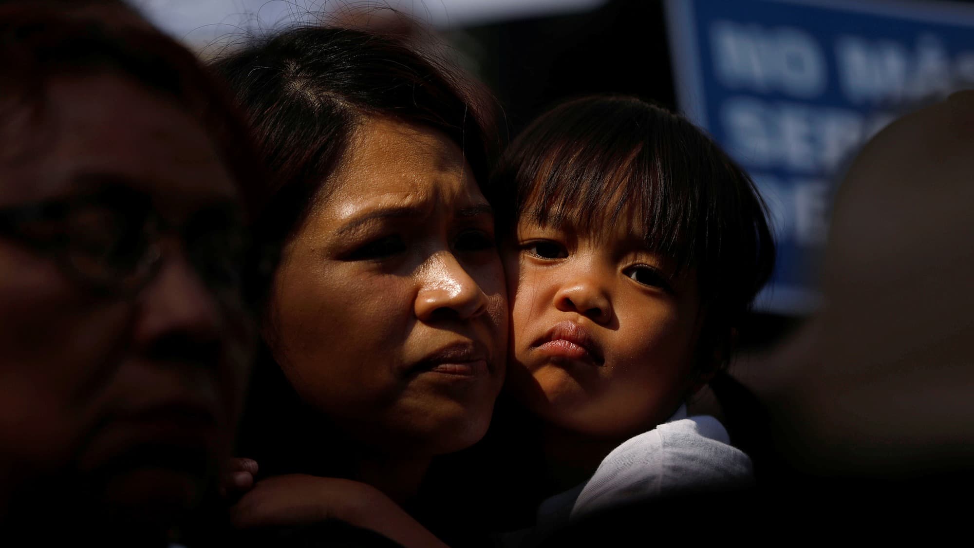 A mother is seen holding her child.