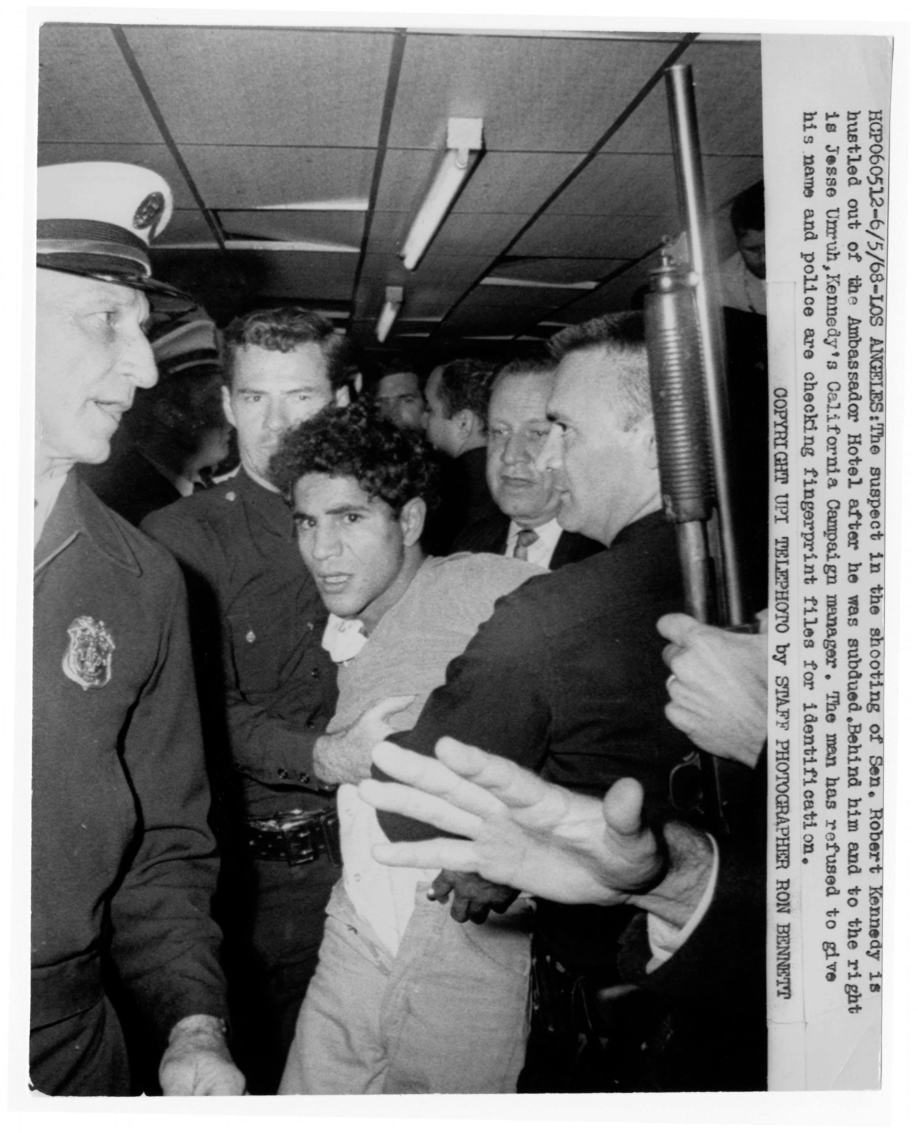Robert Kennedy’s wounded head is cradled as he lies on the kitchen passageway floor just after being shot.