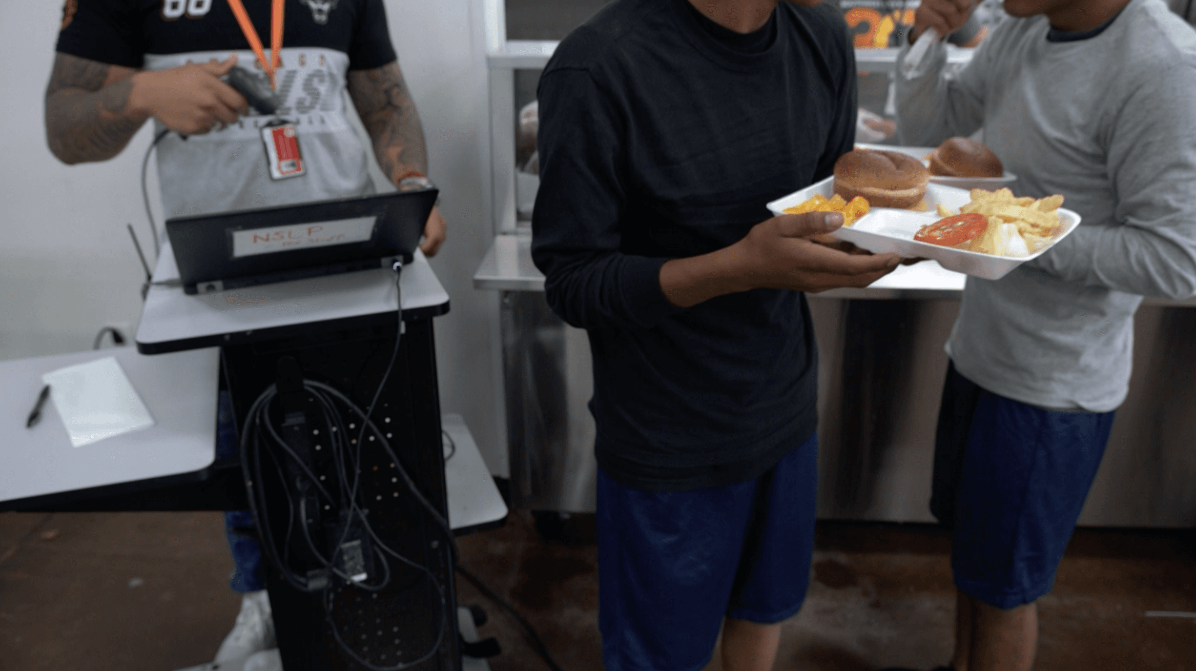 Unaccompanied or separated migrant teenage boys receive one of their daily meals at Casa Padre, a facility for migrant children in Brownsville, Texas.