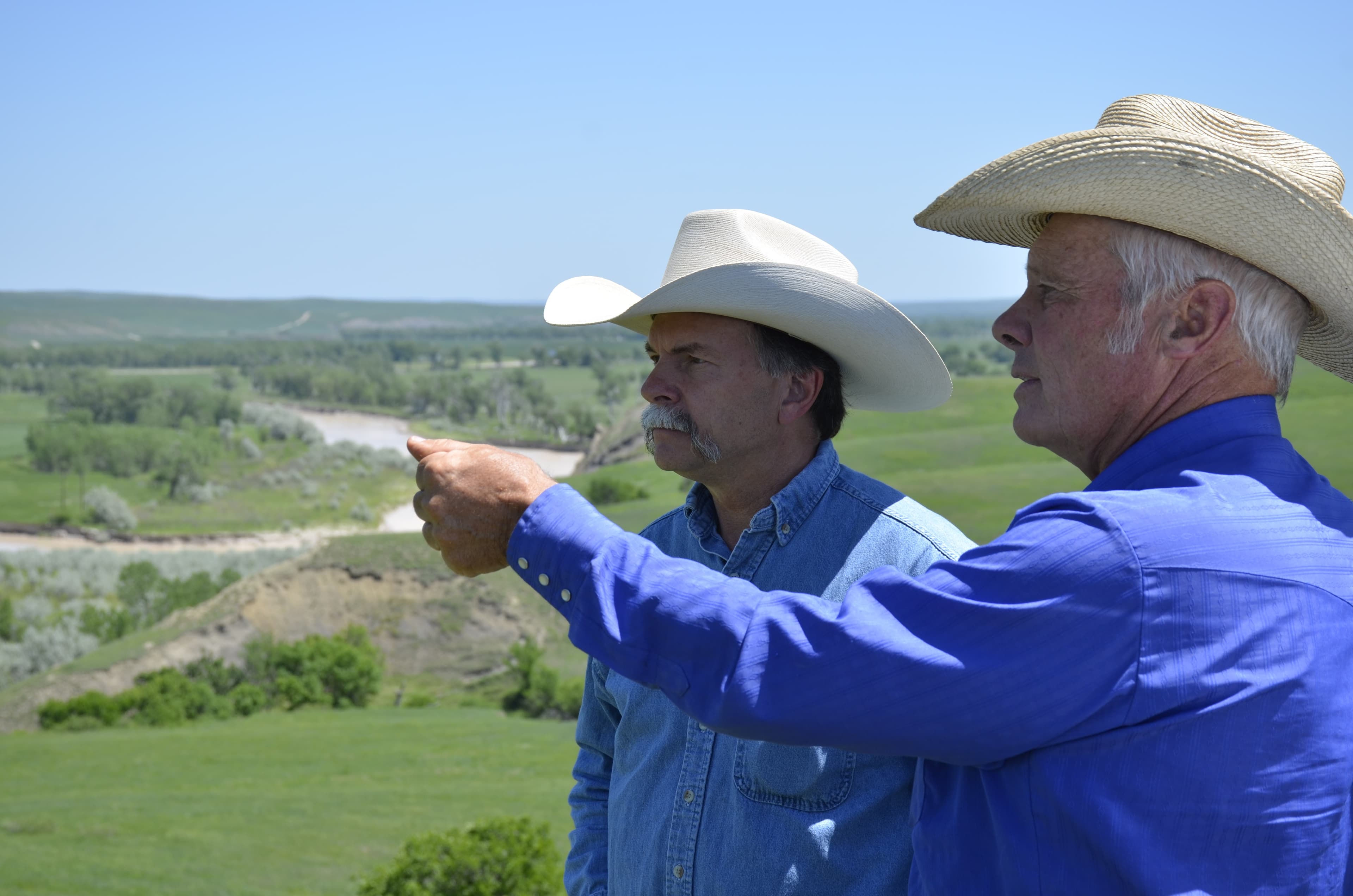 Kenny Fox, right, on his ranch in Belvidere, S.D., with Bill Bullard. The two men with the organization R-CALF USA say imports from Mexico and Canada in the time of NAFTA have taken too great a toll on US ranchers.