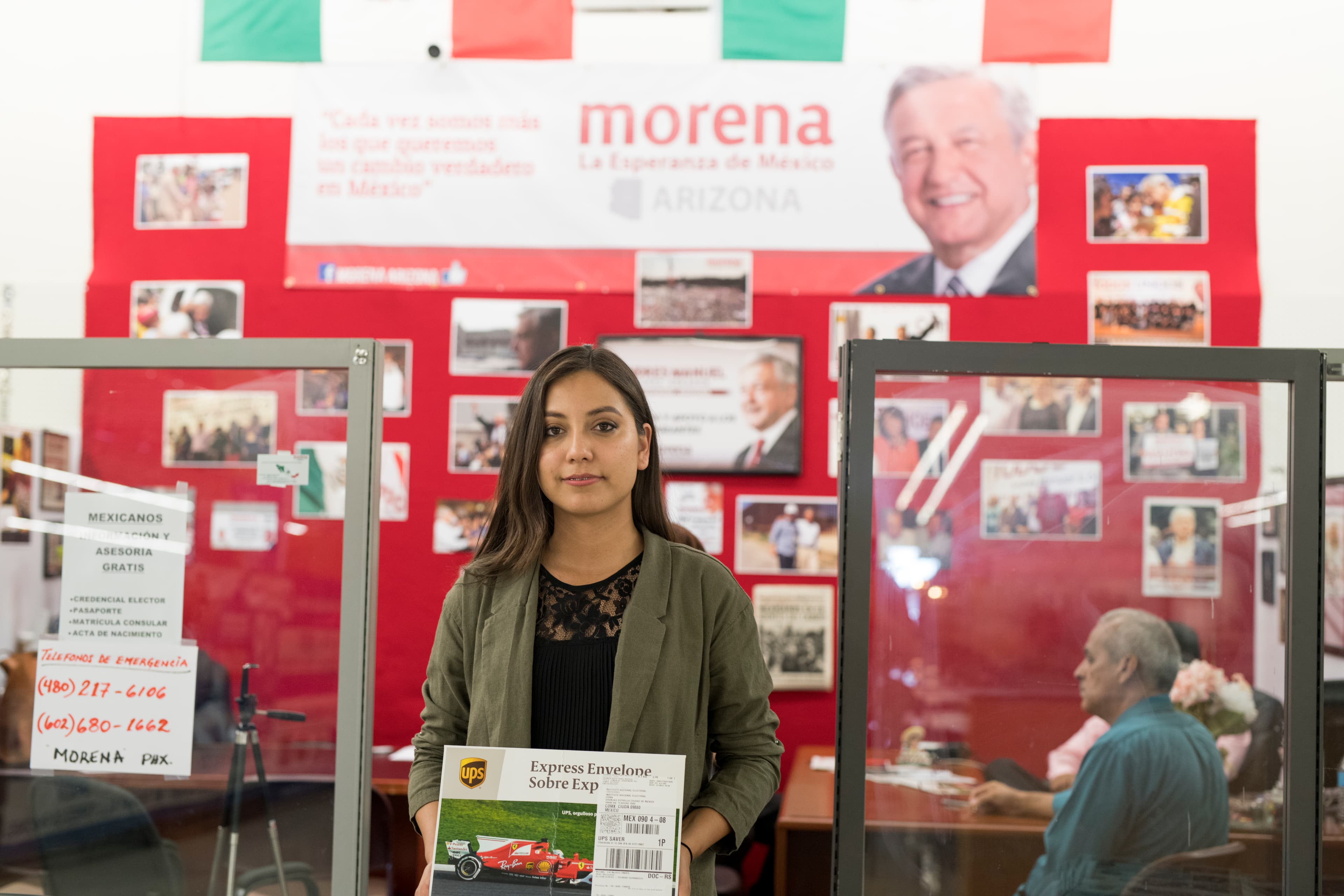Carmen Pérez Noyola, holding an envelope, prepares to mail in her ballot from Phoenix for the July 1 presidential election in Mexico.
