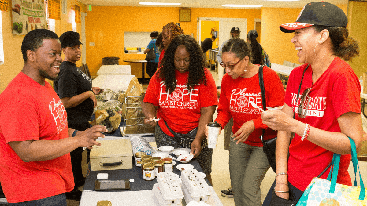young people laugh around a table