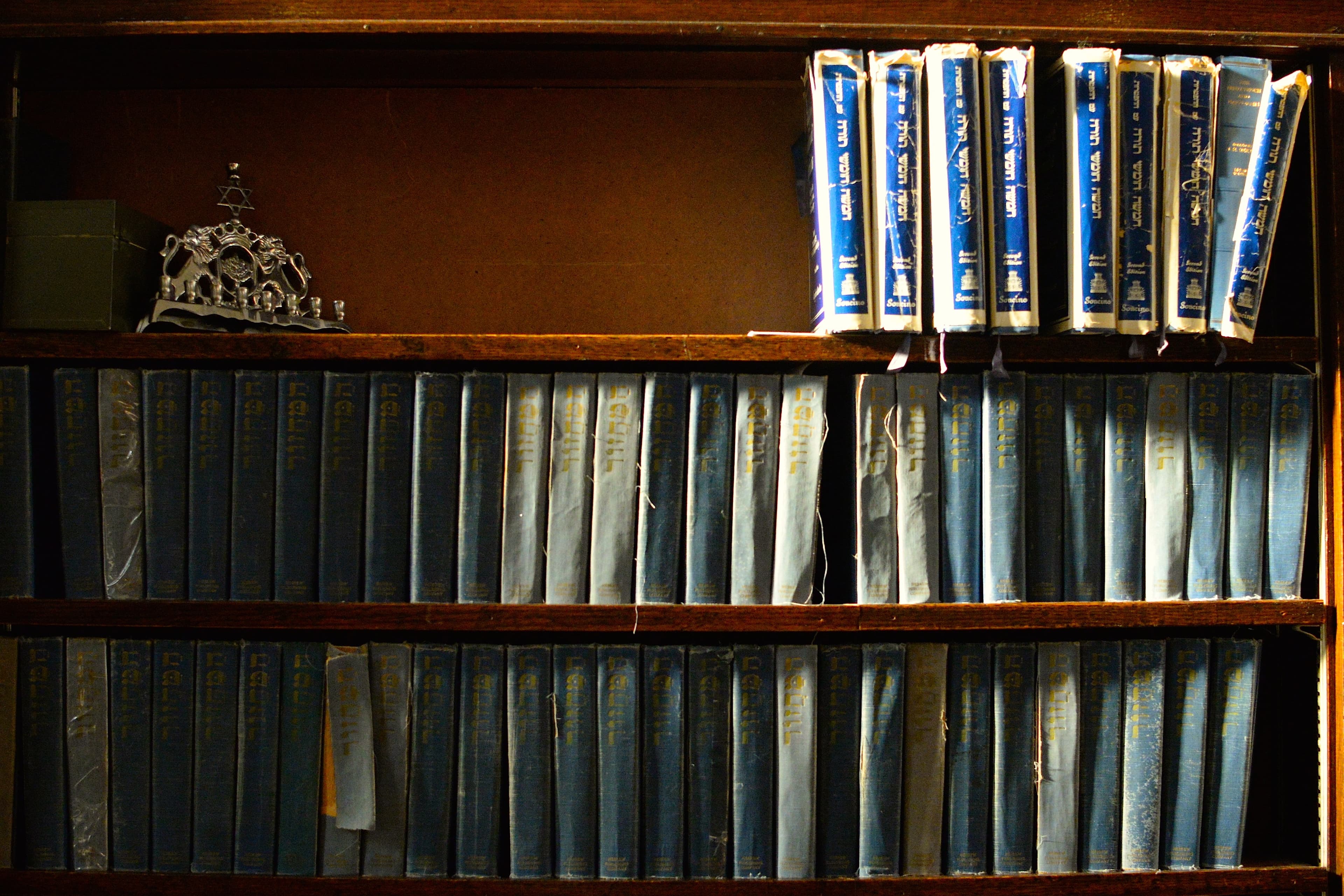 Religous texts on three bookselves