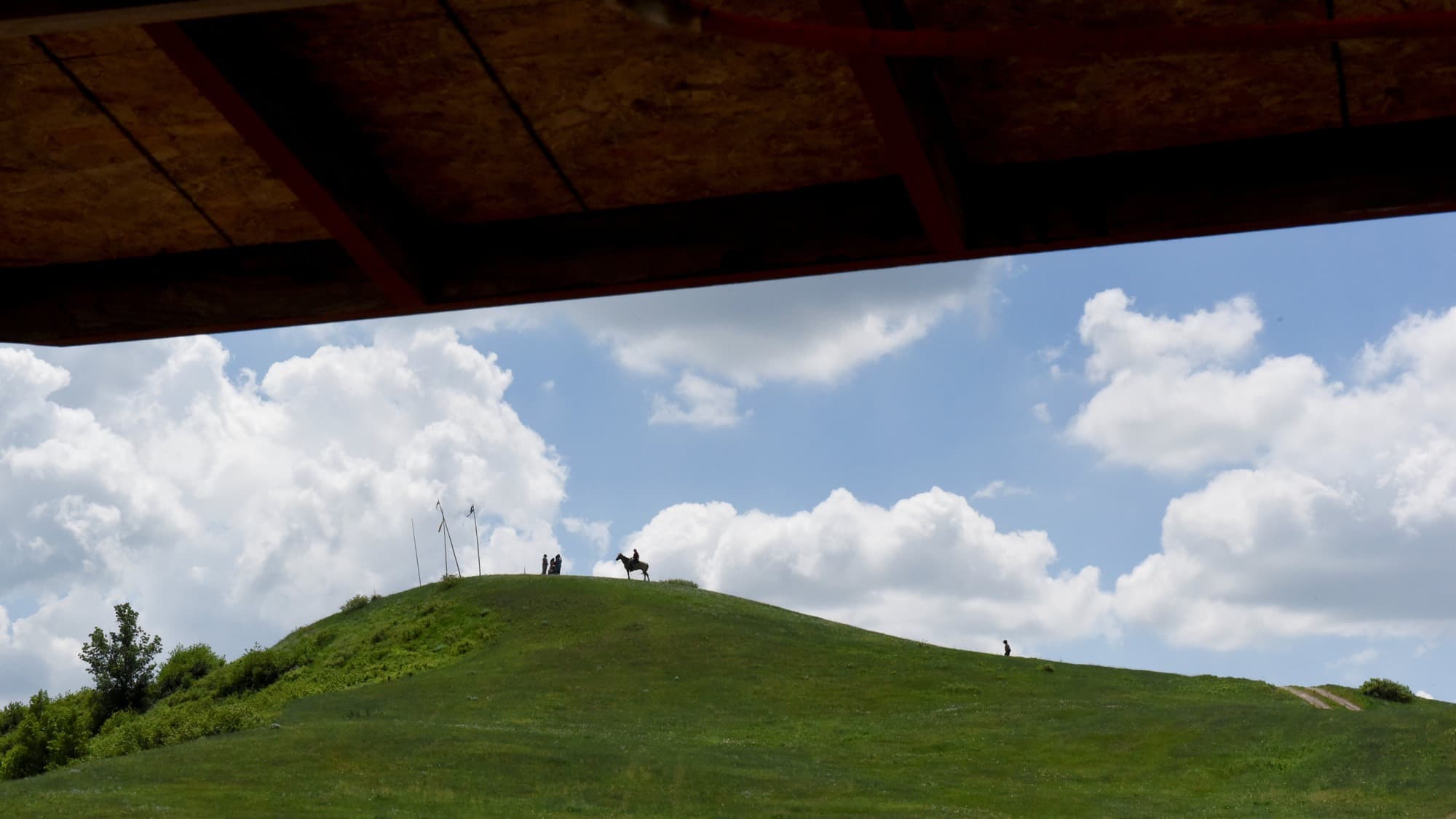 Jayden Lookinghorse, riding his horse, stands on top of a hill on the Cheyenne River Reservation South Dakota.