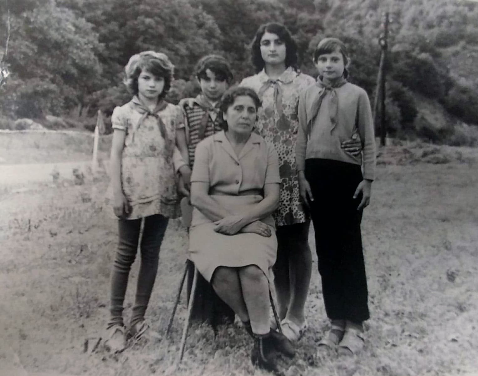 Four members of the Young Pioneers pose with an older woman