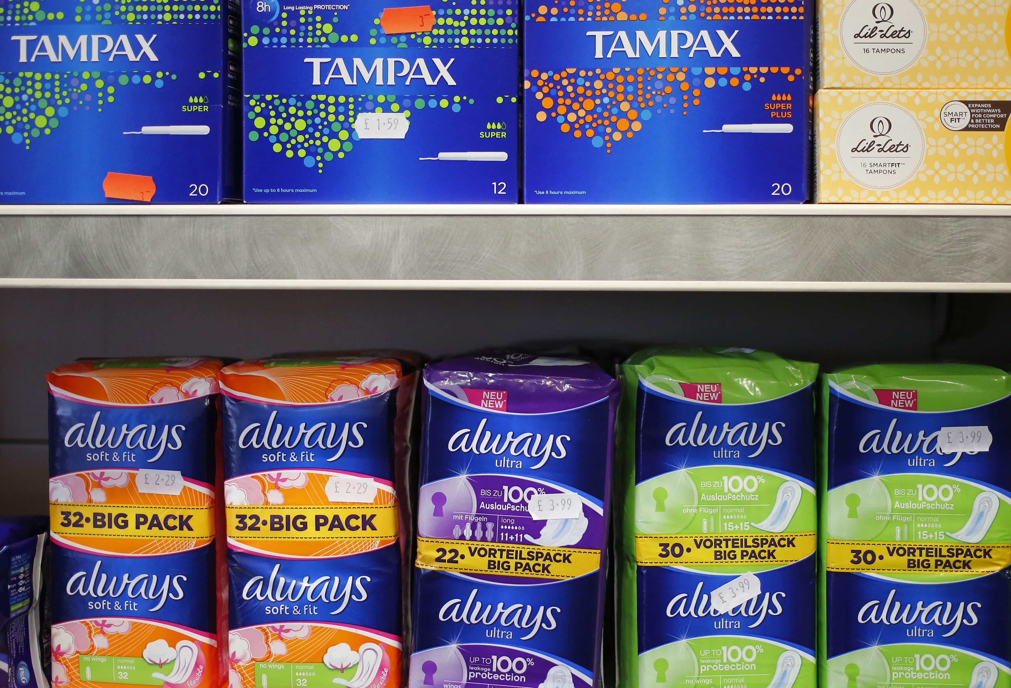Feminine hygiene products are seen stacked on a shelf