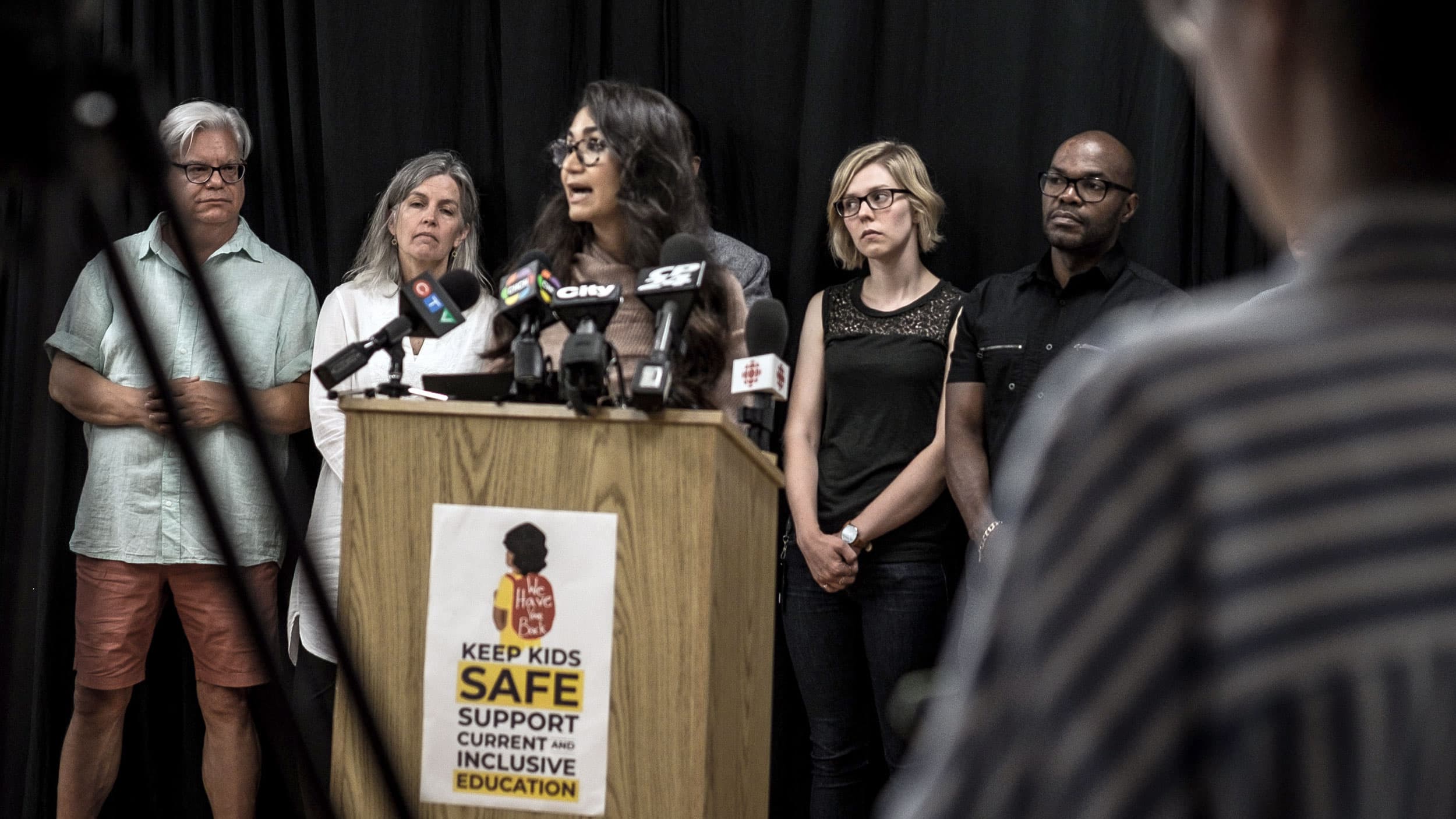 A woman speaks behind a podium