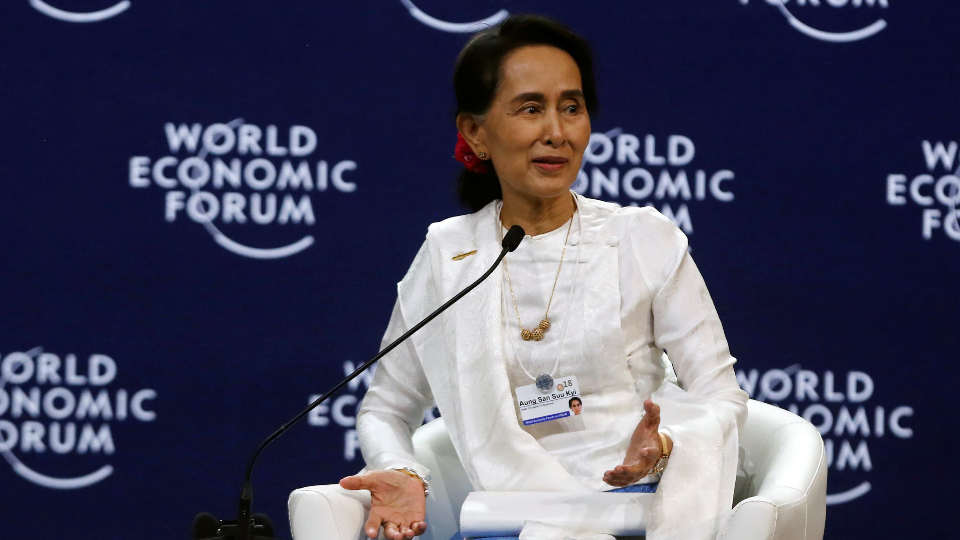 Aung San Suu Kyi  on a stage dressed in white