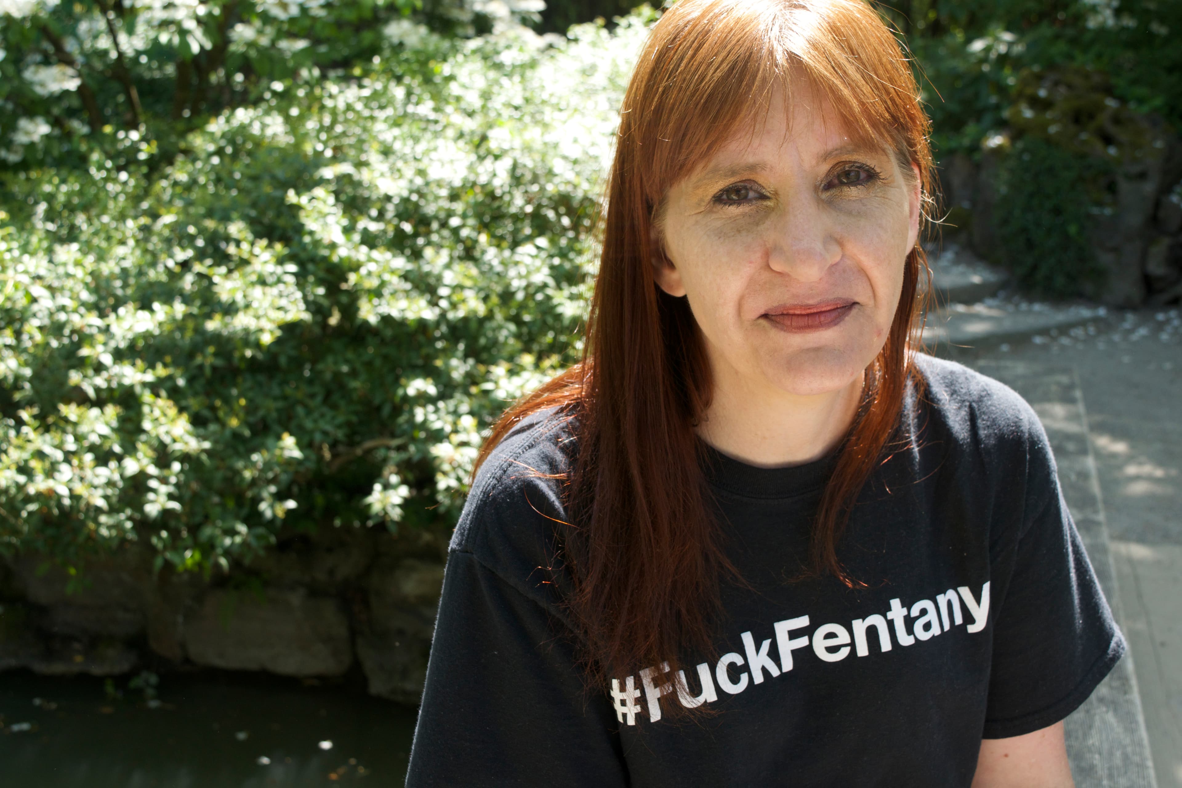 a woman with red hair wearing a black t shirt