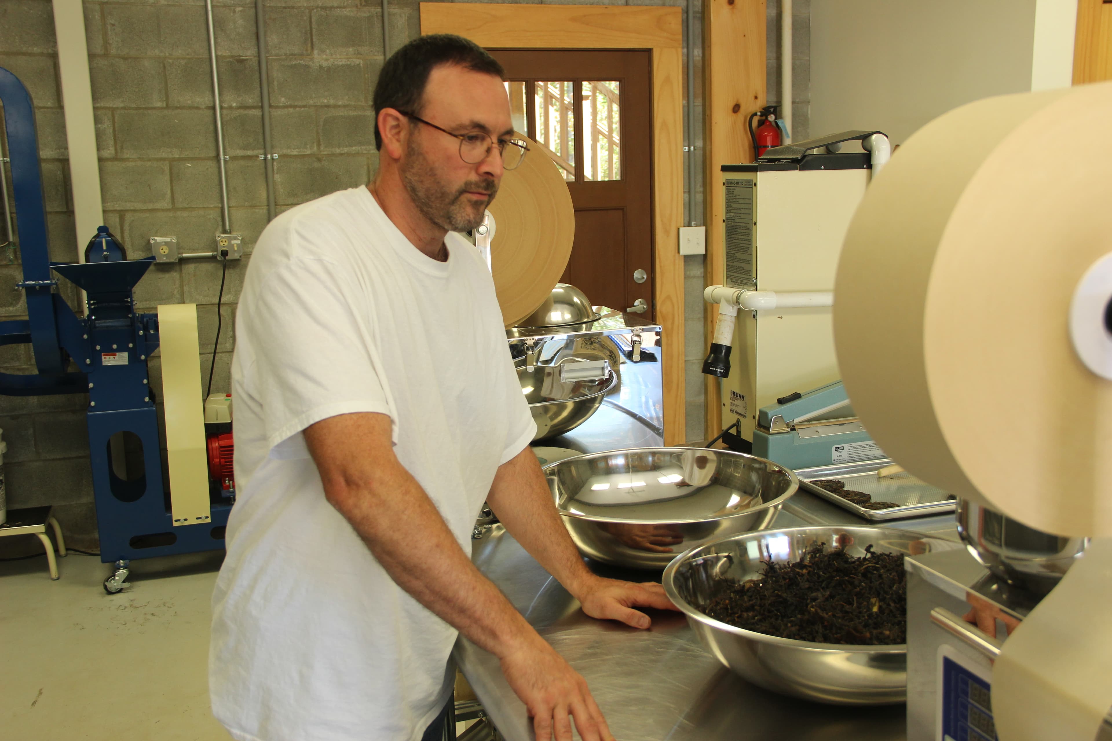 Steve Lorch in his garage turned “micro factory.” He estimates that it costs about $250,000 to start a small tea company in the US. He has been able to set up shop for a fraction of that cost, getting creative and tinkering with some of his machines.