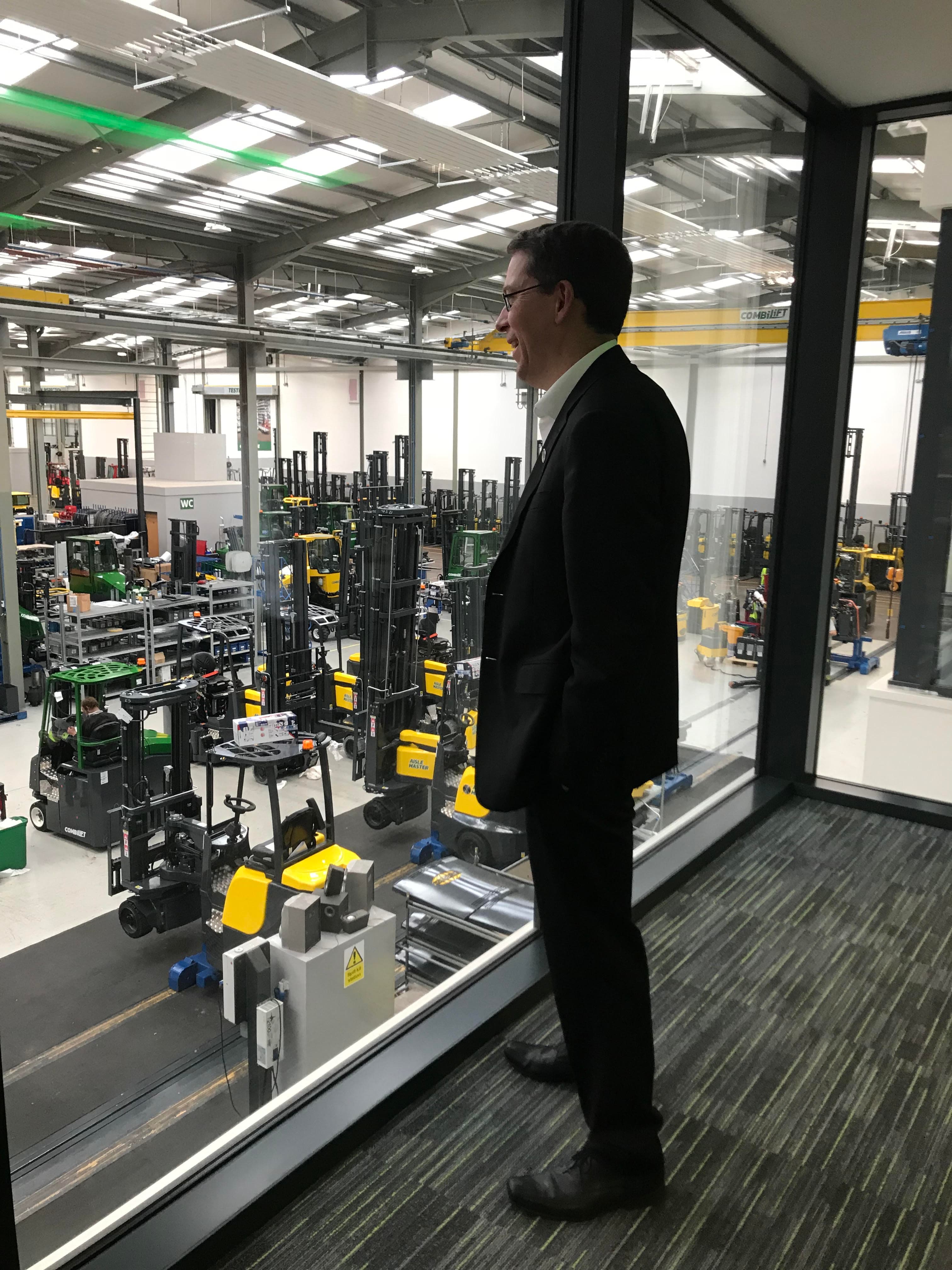 the manager of a forklift factory looks out at the plant in ireland