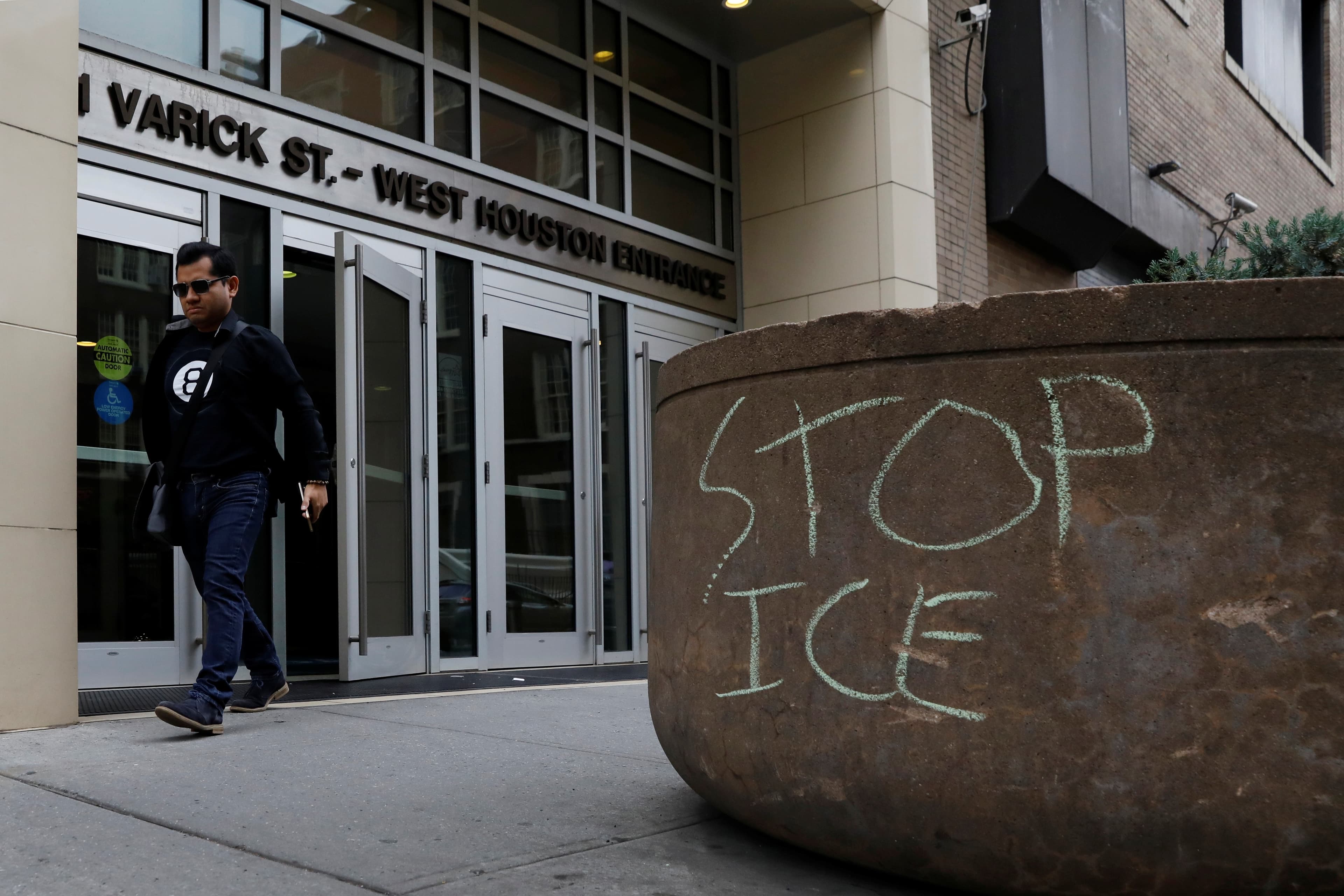 An officer stands outside the ICE offices in New York City
