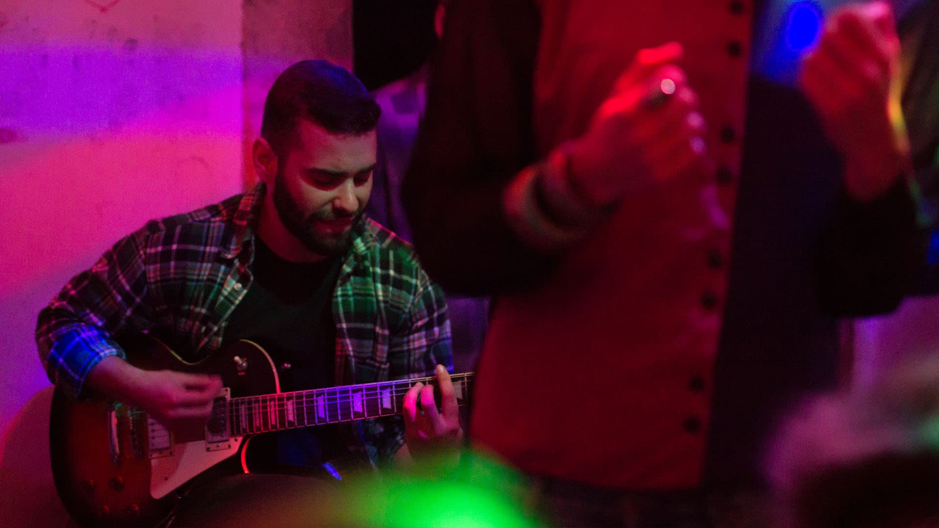 guitarist João Caçador performing while sitting down