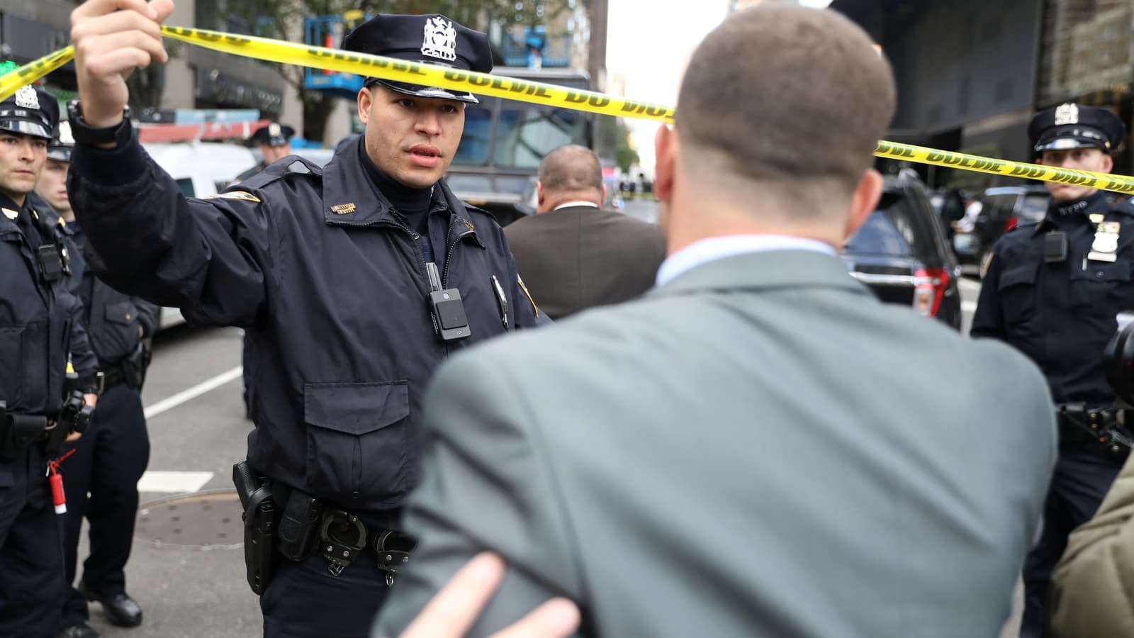 Police allow someone to pass outside the Time Warner Center