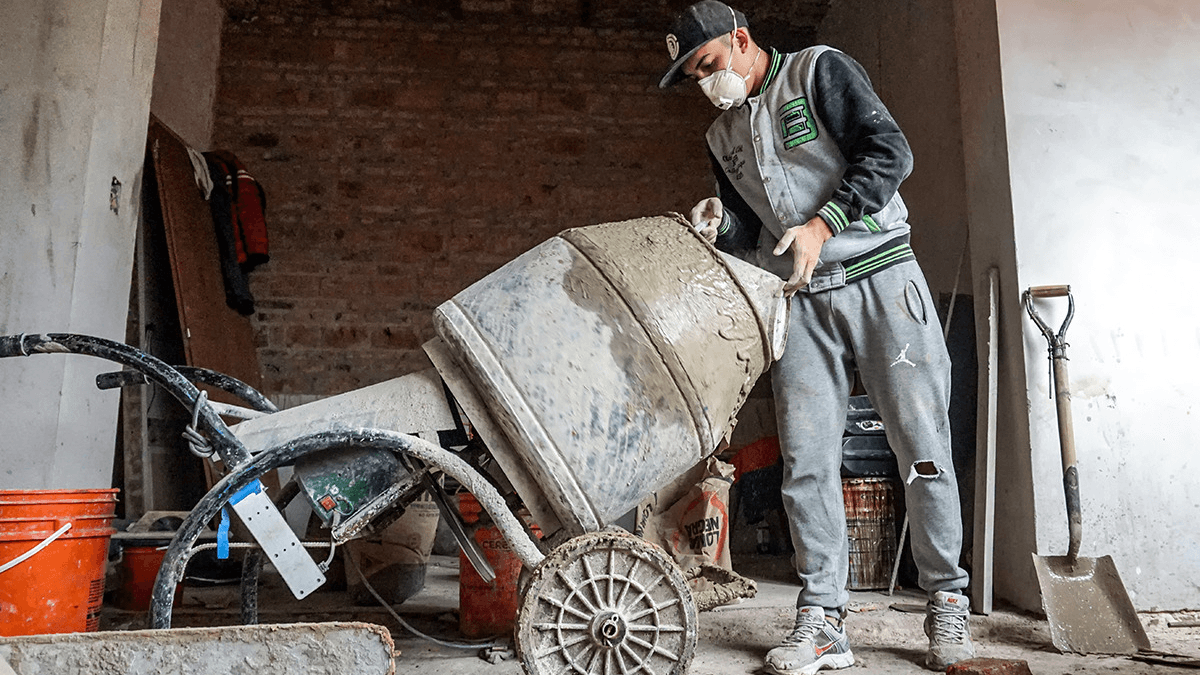a man mixes cement in argentina