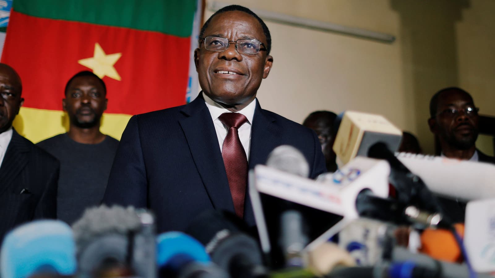 Cameroon opposition candidate smiles during a news conference at his headquarters in Yaoundé, Cameroon