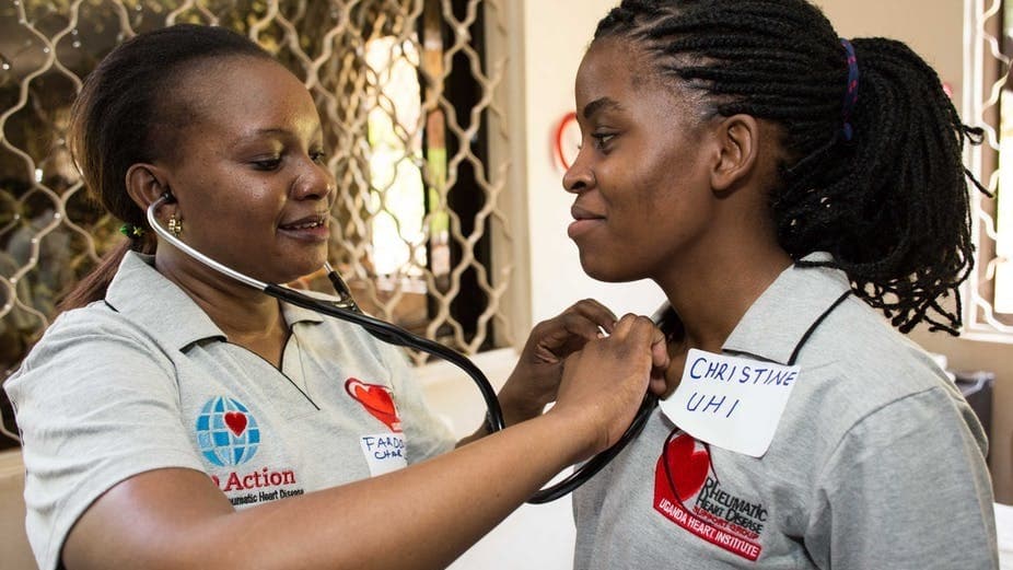A nurse uses a stethoscope to listen for heart problems