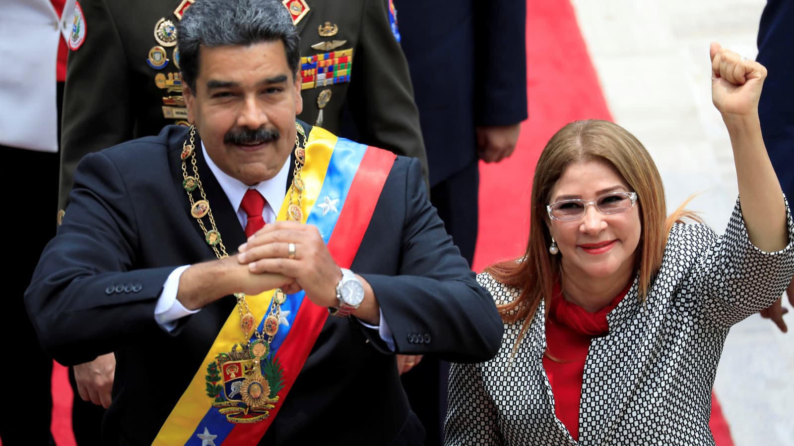 Venezuela's President Nicolás Maduro and his wife Cilia Flores gesture during arrival for special session