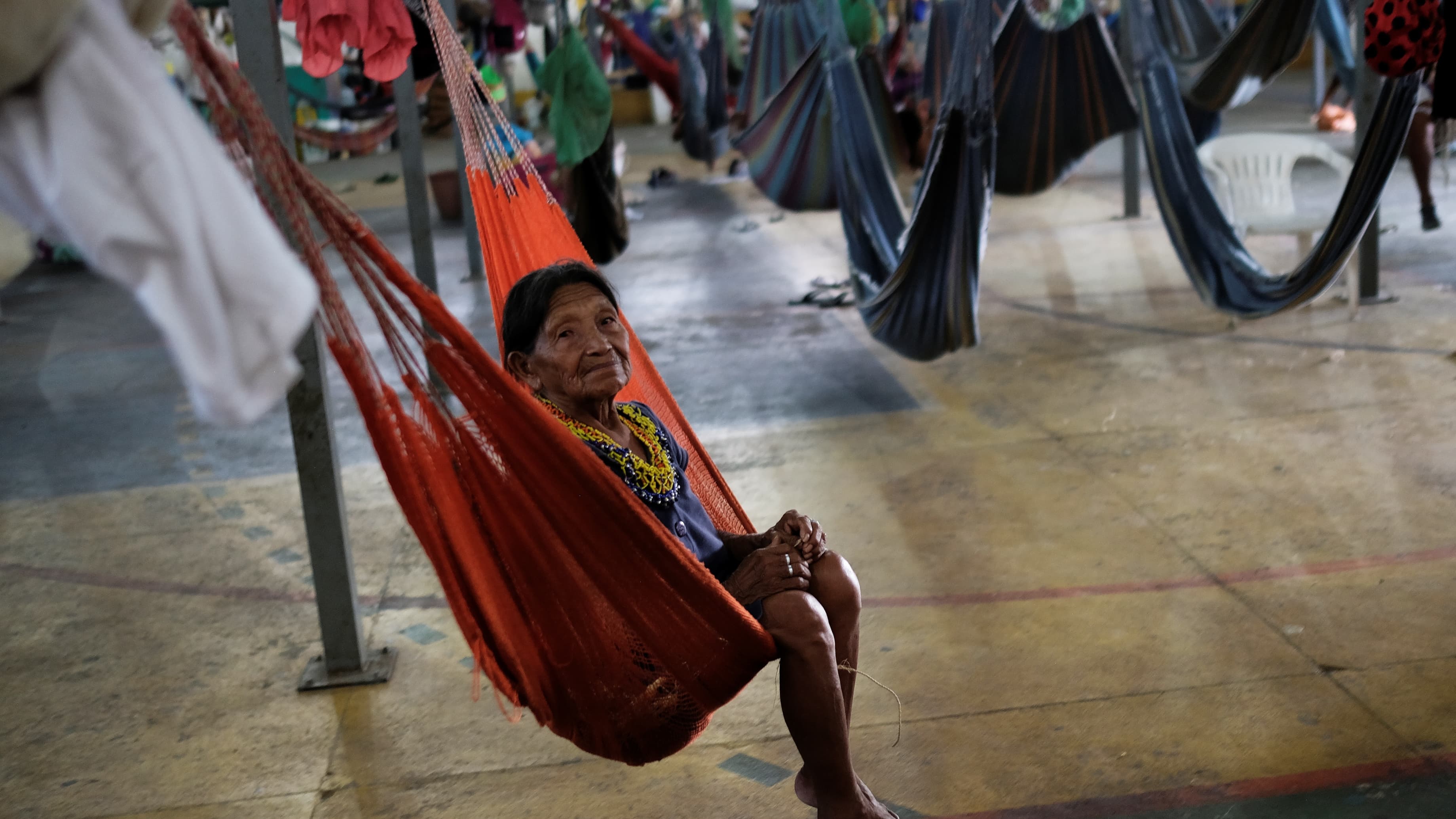 An indigenous Warao woman from Venezuela swings in a hammock at a shelter in Brazil