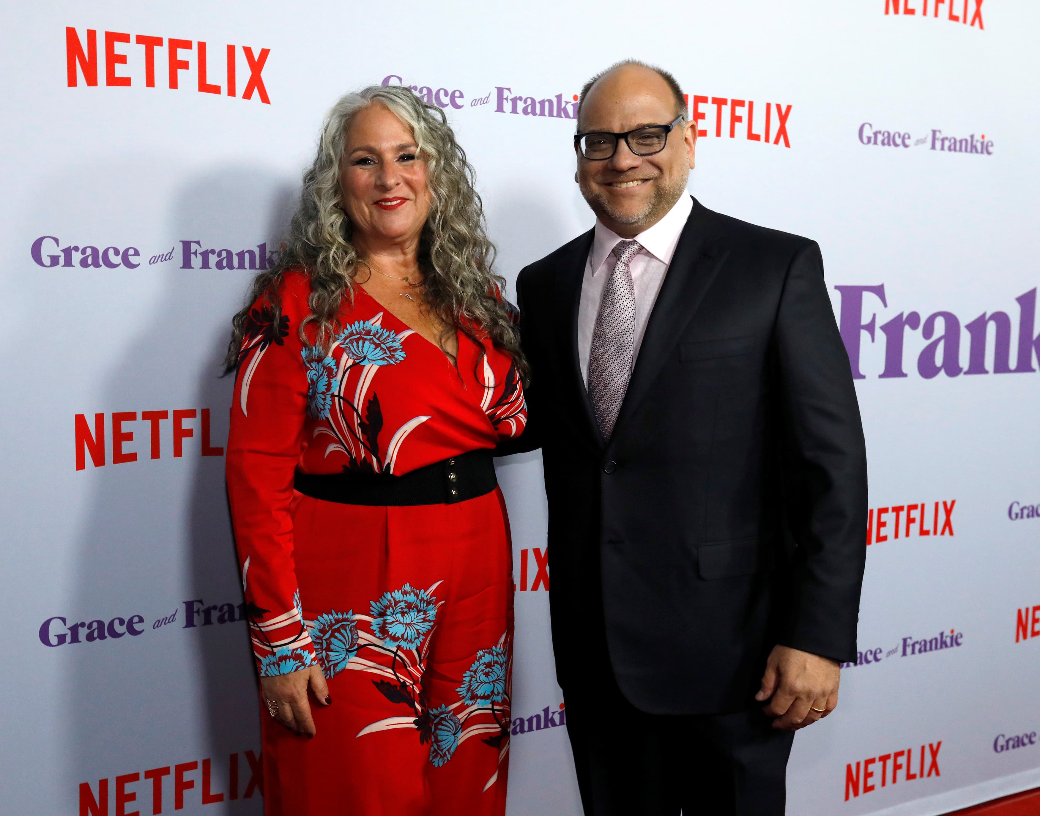 Marta Kauffman and Howard J. Morris pose in front of a white screen