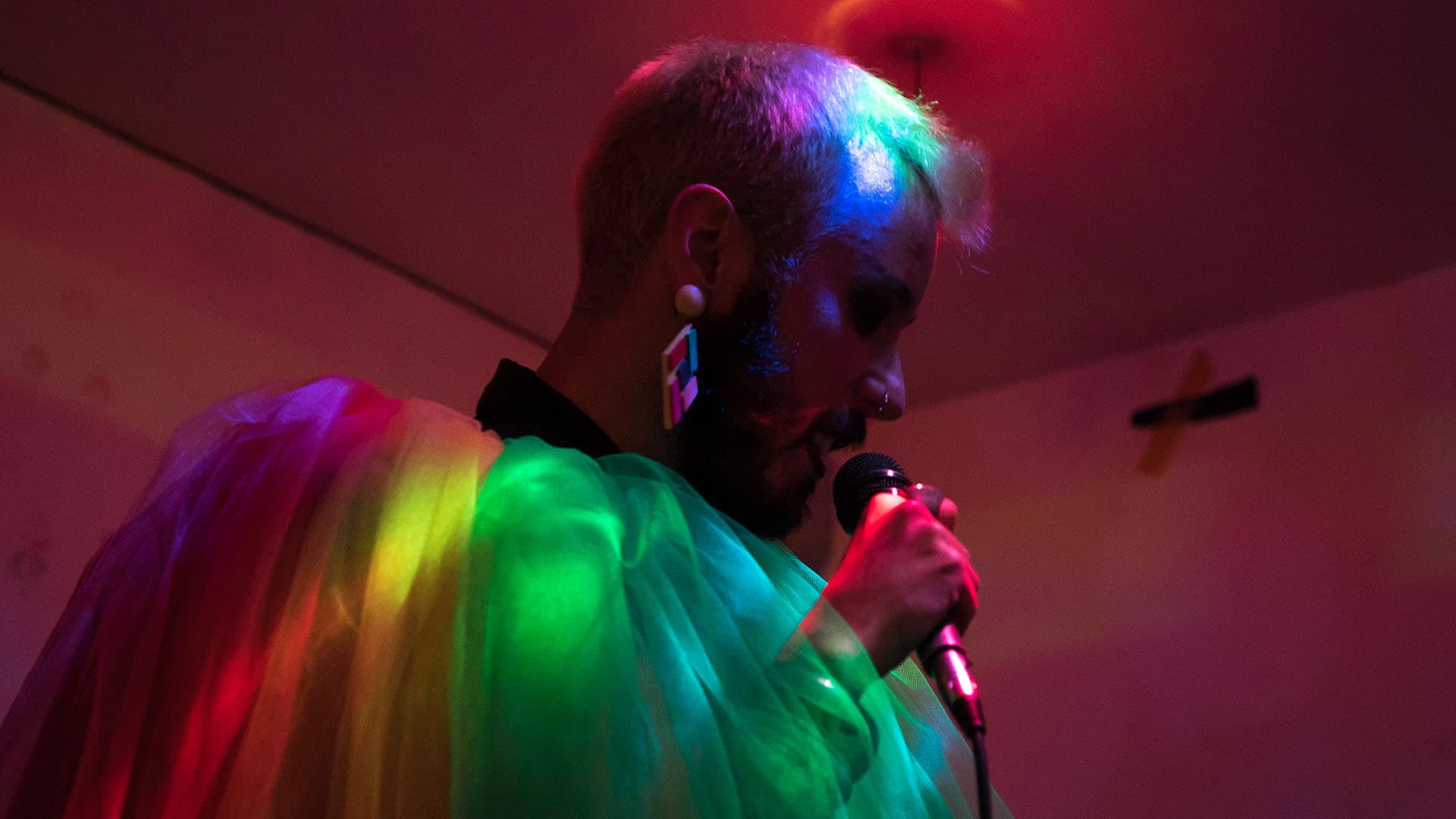 Tiago Lila dressed in a rainbow cloak