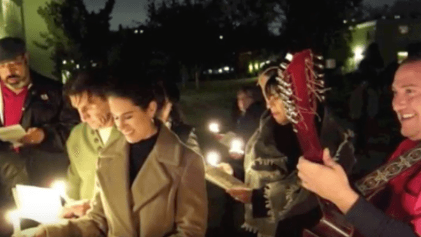 A group of carolers holding candles