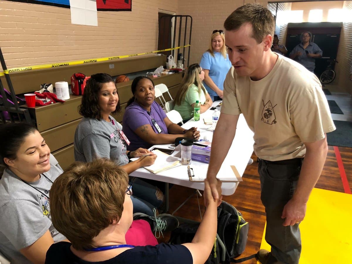 a politican works the crowd at a shelter
