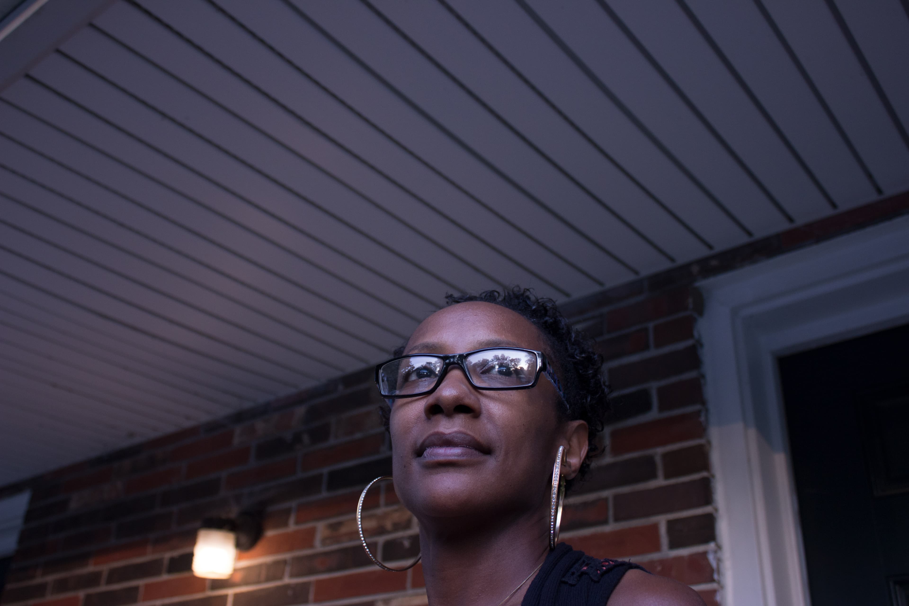 a woman stands in front of her home in st louis