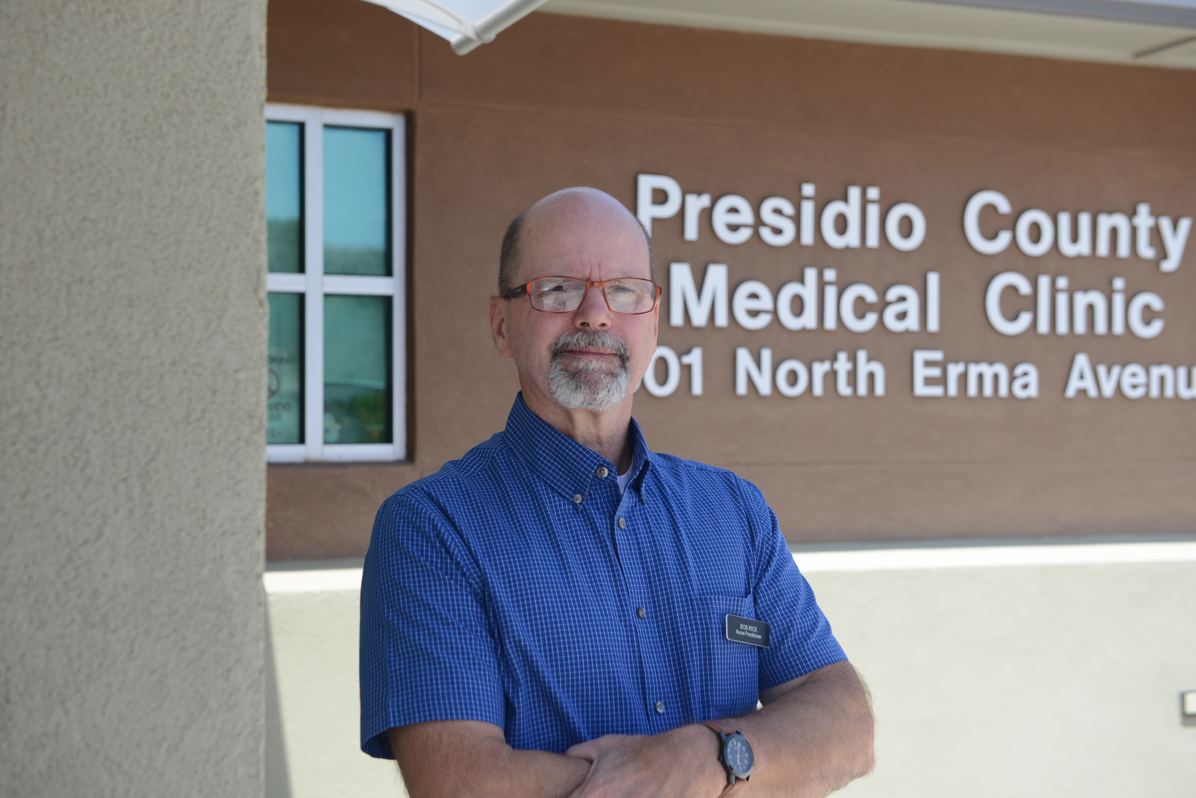 a man stands in front of a clinic in texas