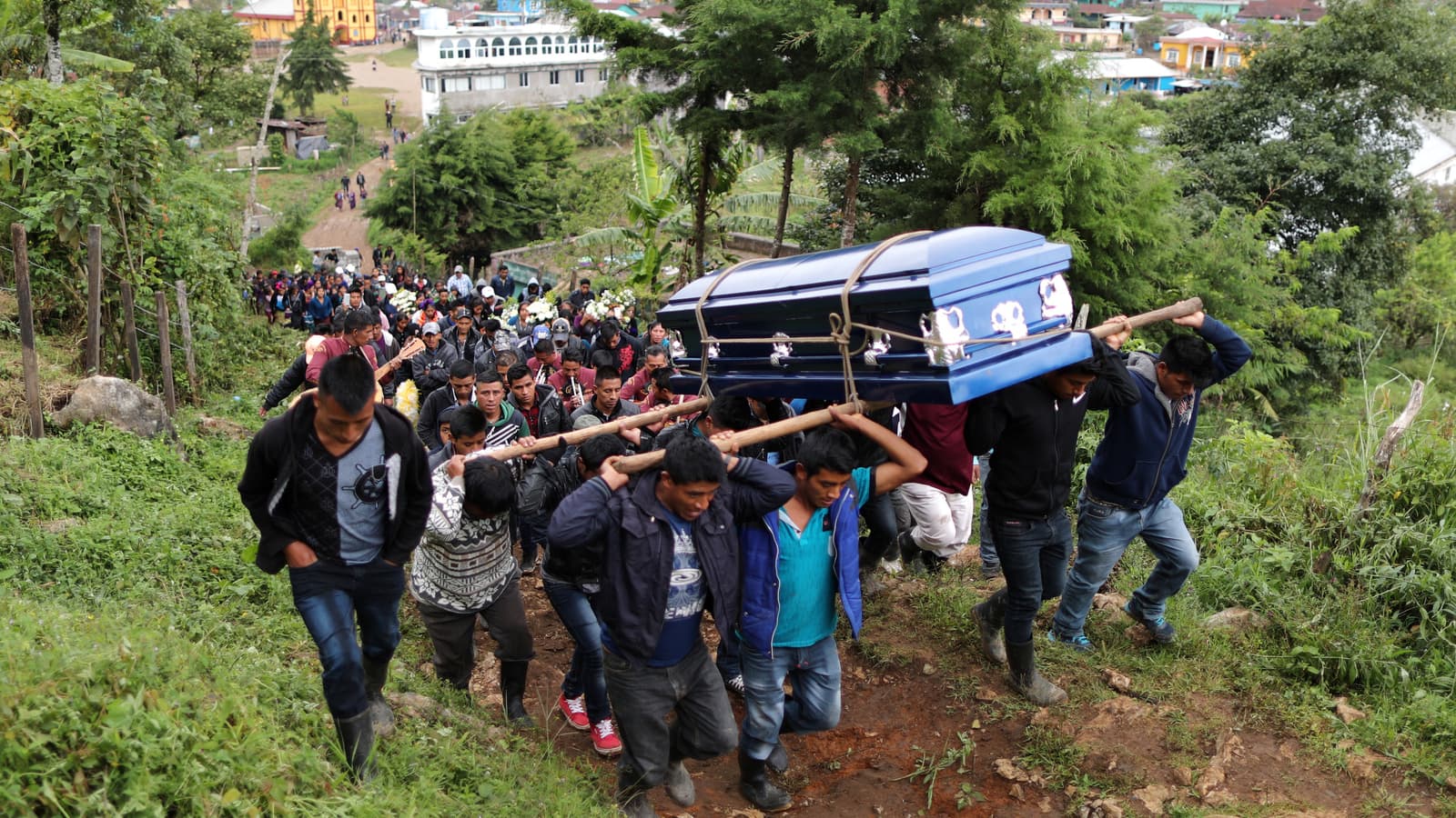 Pallbearers carry Misael Paiz's coffin.