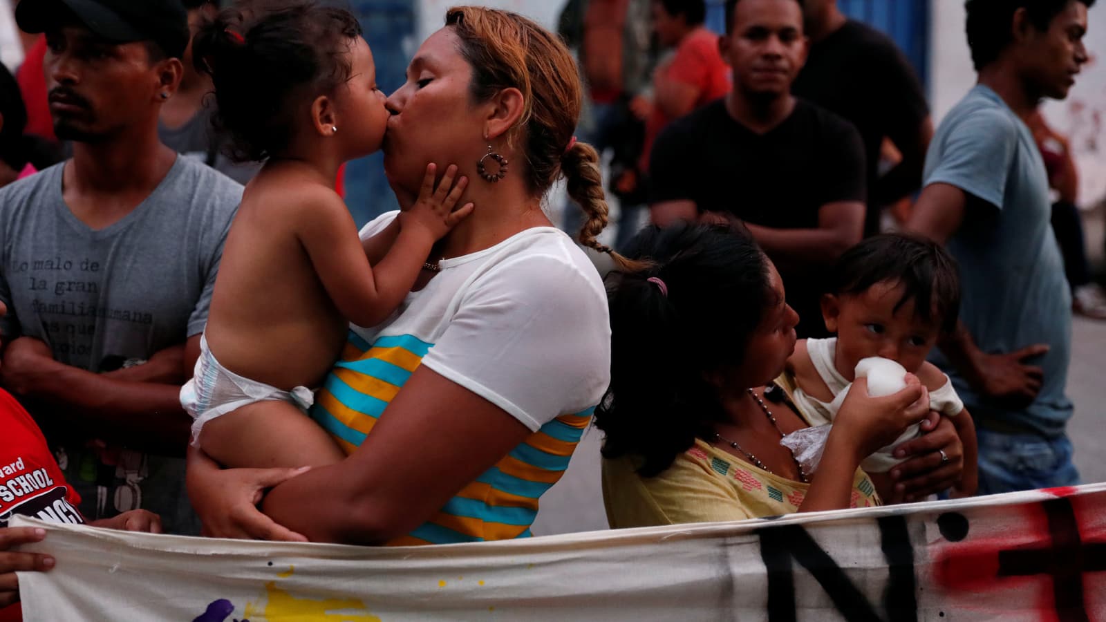 A mother receives a kiss from her toddler.