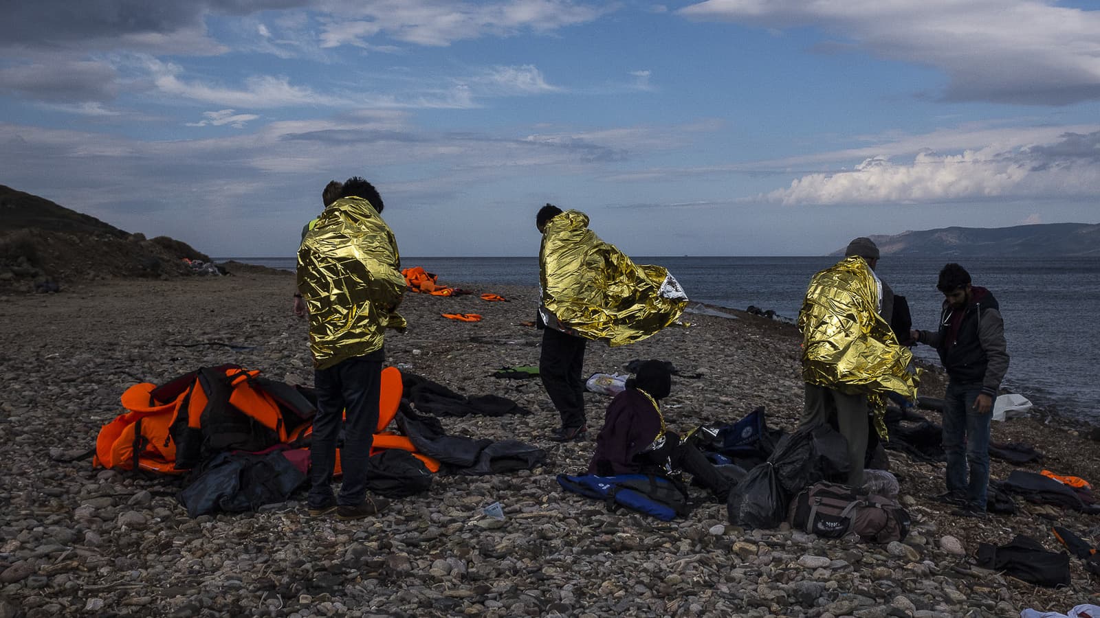 Refugees wrapped in gold reflective blankets to stay warm.