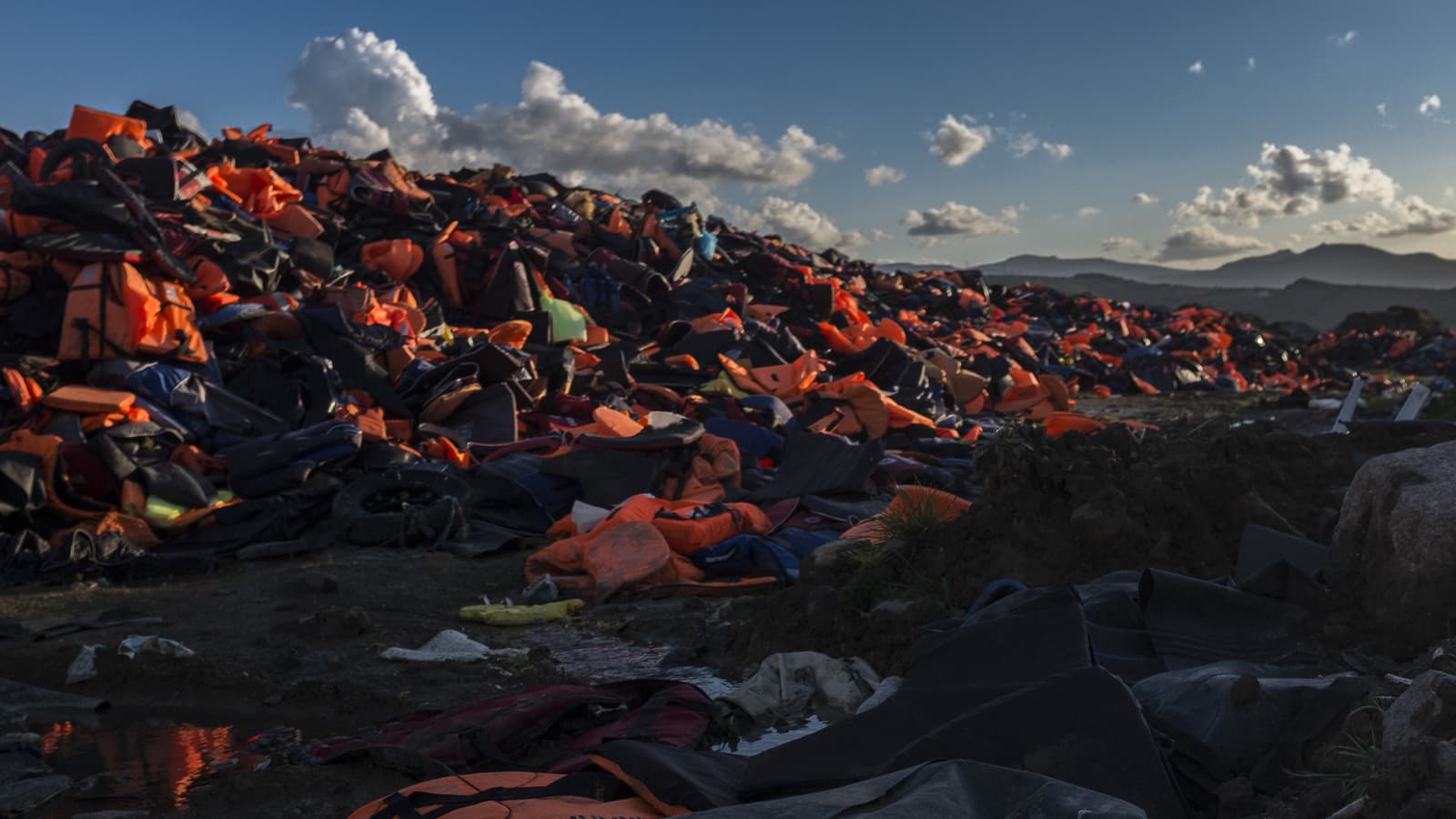 Orange life jackets in a heap.